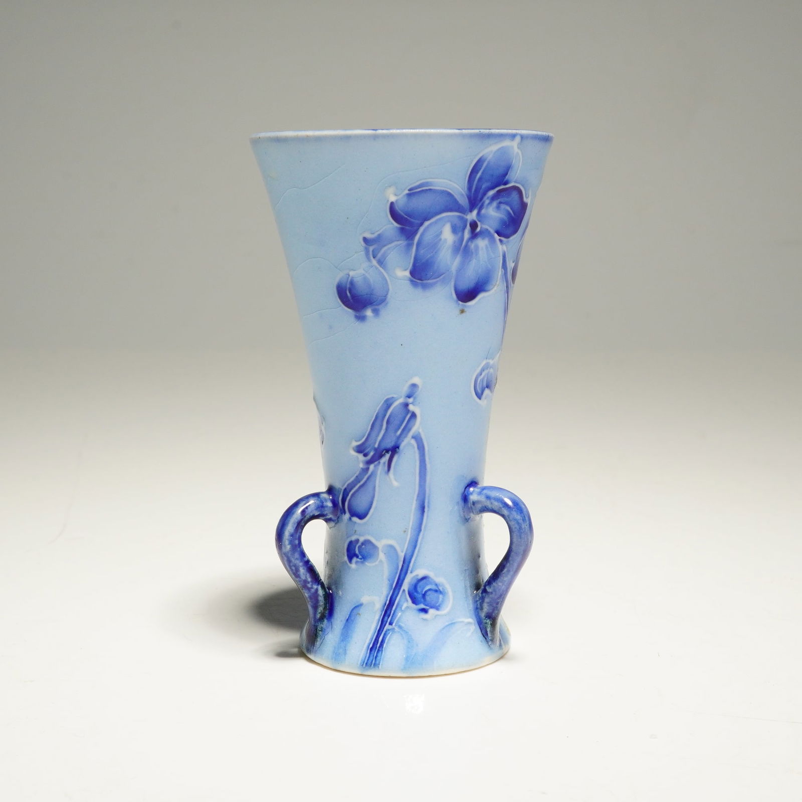 Macintyre Moorcroft Florian Miniature Vase, Violet: Decorated in the Florian style with violet motifs, bearing a printed Macintyre mark in brown and painted initials, designer's mark in green. The provenance includes a label for MacMillan & Perrin, "Mo