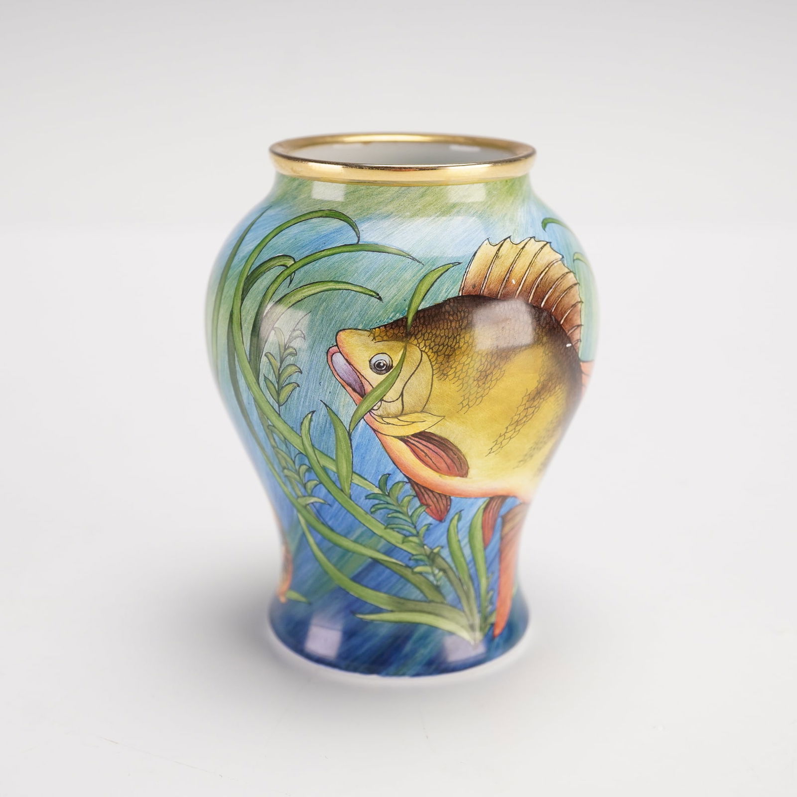 Moorcroft Enamels by Philip Gibson Miniature Trial Vase: A small pottery vase with underwater designs, depicting swimming fish in the reef. Artist marking to underside. Moorcroft backstamp. Artist: Philip Gibson Dimensions: 2"W x 2.75"H Country of Origin: E