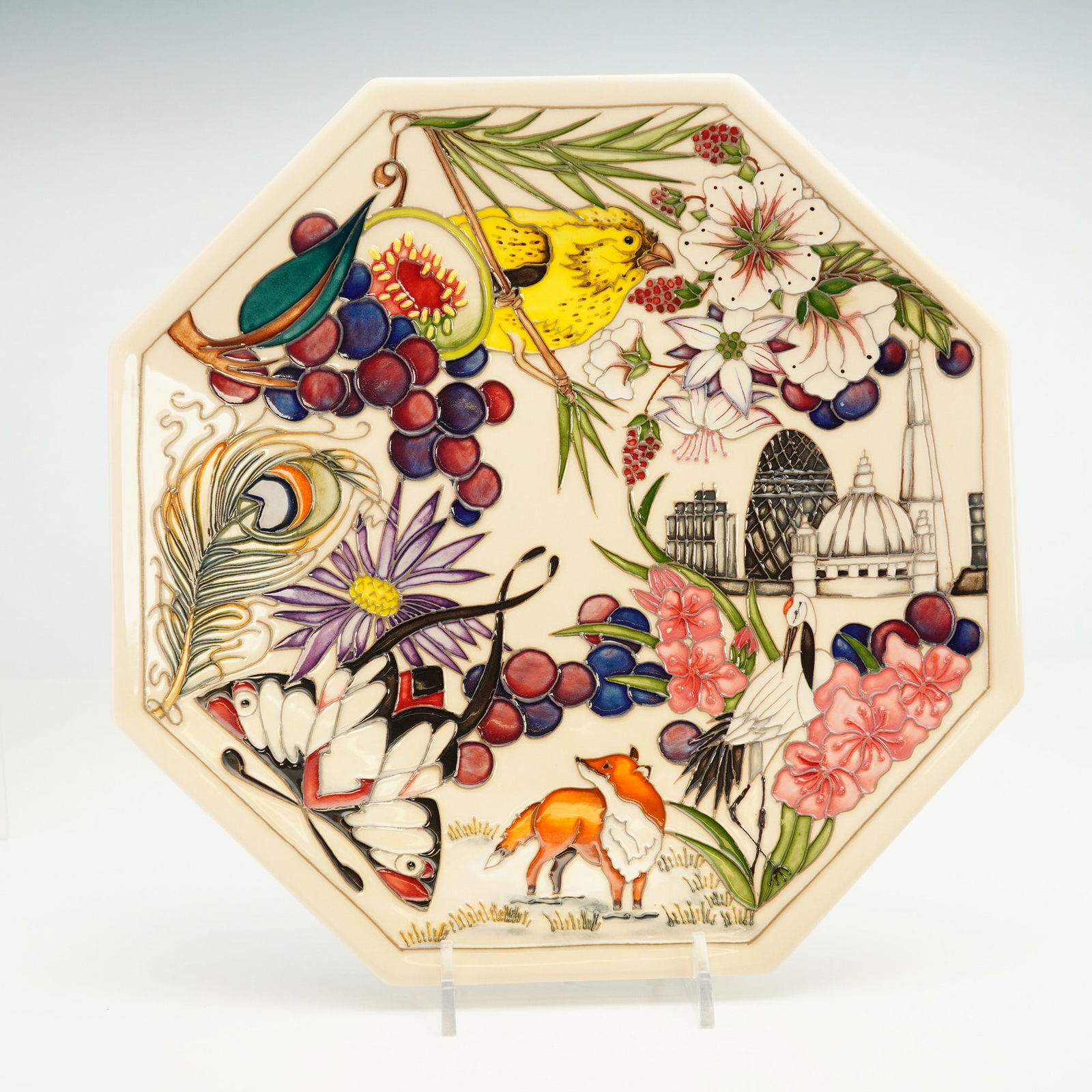 Moorcroft Pottery Multiple Artists Signature Plate: Octagonal plate with tube-lined design of bird, fox, buildings and florals. Yellow, green, red and pink coloration has been hand painted into design. Reverse has signatures of all designers in green i