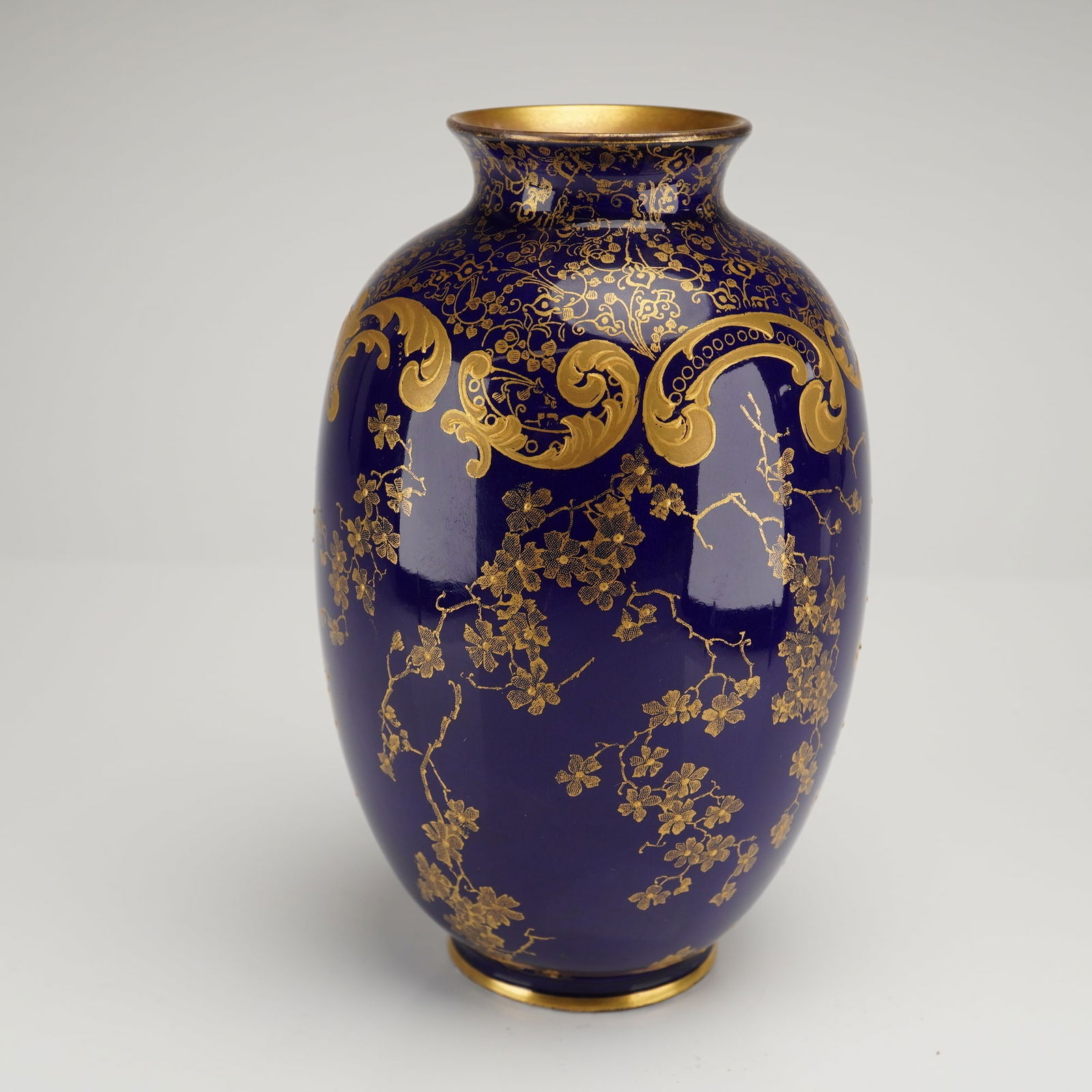 Royal Doulton Gilt Cobalt Baluster Vase: This is a single porcelain vase of baluster form, dating to the late Victorian or Edwardian period, consistent with the style and the visible printed mark. The body is covered in a deep, glossy cobalt