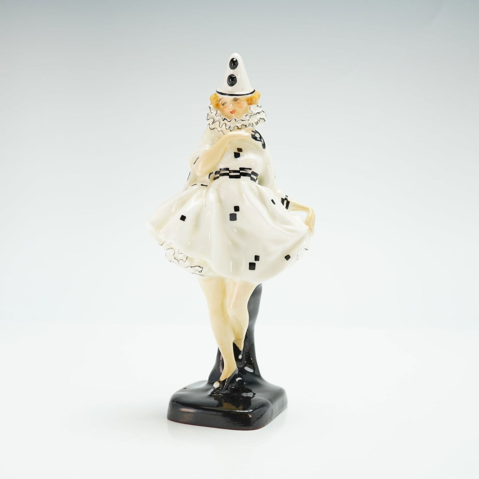Royal Doulton Figurine, Pierrette HN644: Hand painted porcelain figure of a pierrette in black and white dress and conical hat. Royal Doulton backstamp on base. Artist: Leslie Harradine Issued: 1924 - 1938 Dimensions: 7"H Country of Origin: