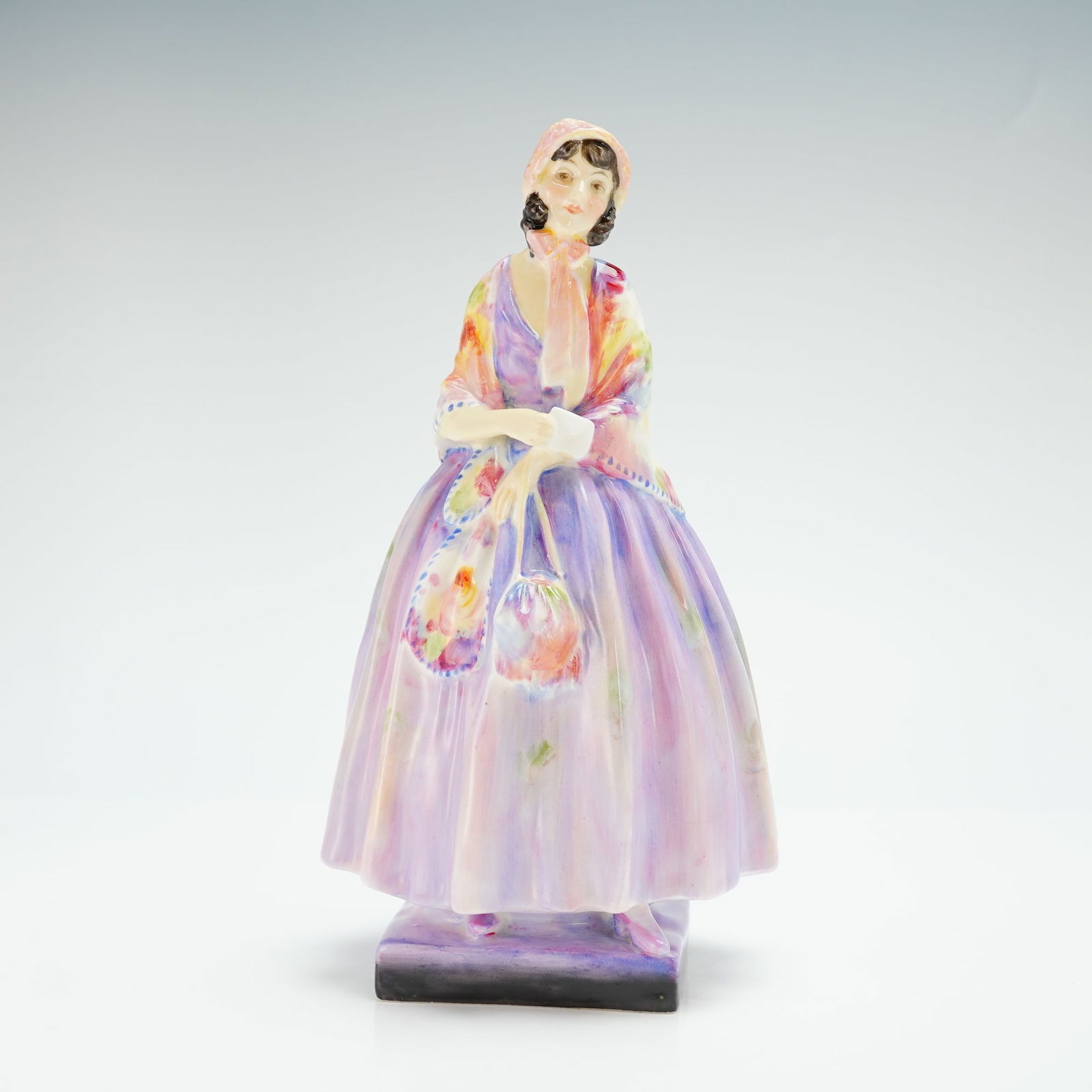 Royal Doulton Figurine, Barbara HN1432: Early piece in the Harradine Classics series, modeled in lavender gown with colorful shawl. Royal Doulton backstamp. Artist: Leslie Harradine Issued: 1930 - 1951 Dimensions: 4.75"L x 8.5"H Country of