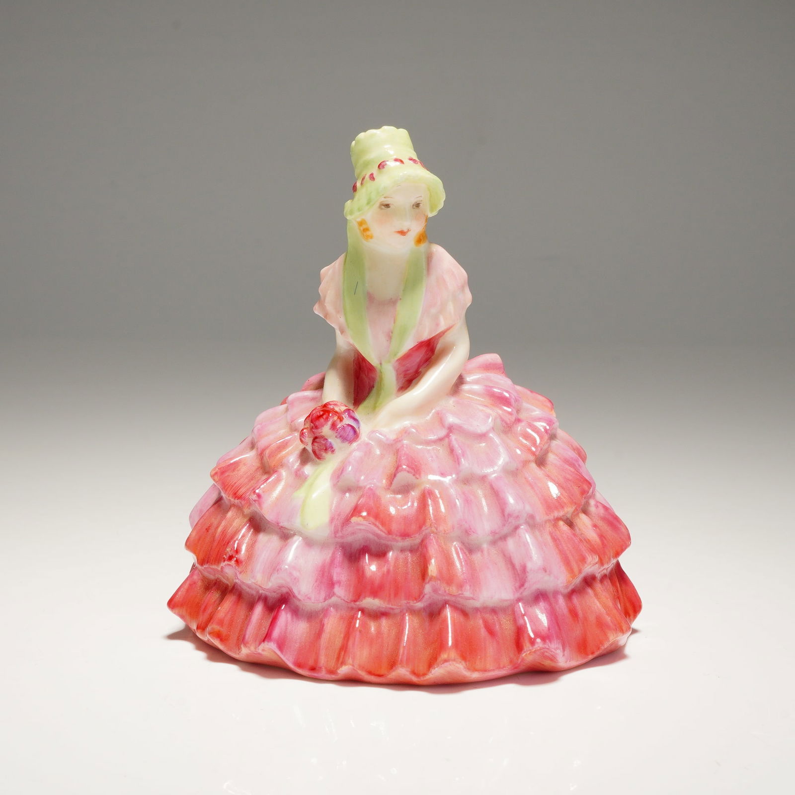 Royal Doulton Miniature Figurine Chloe M9: A single multi-colored porcelain figurine, identified as "Chloe M9," depicting a woman in a pink ruffled dress and marked "ROYAL DOULTON ENGLAND" on the base. Dimensions: 2.75"L x 2.25"W x 2.75"H Weig