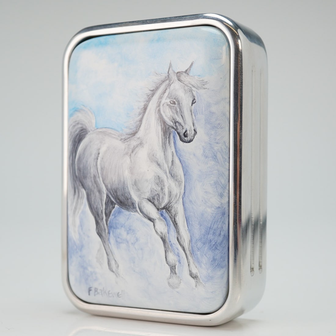 Elliot Hall Enamels by Fiona Bakewell Paperweight, Horse: Limited edition paperweight designed and signed by Fiona Bakewell. Front panel has horse design colored in white, grey and blue. Reverse has Elliot Hall mark with edition number. This item has its ori