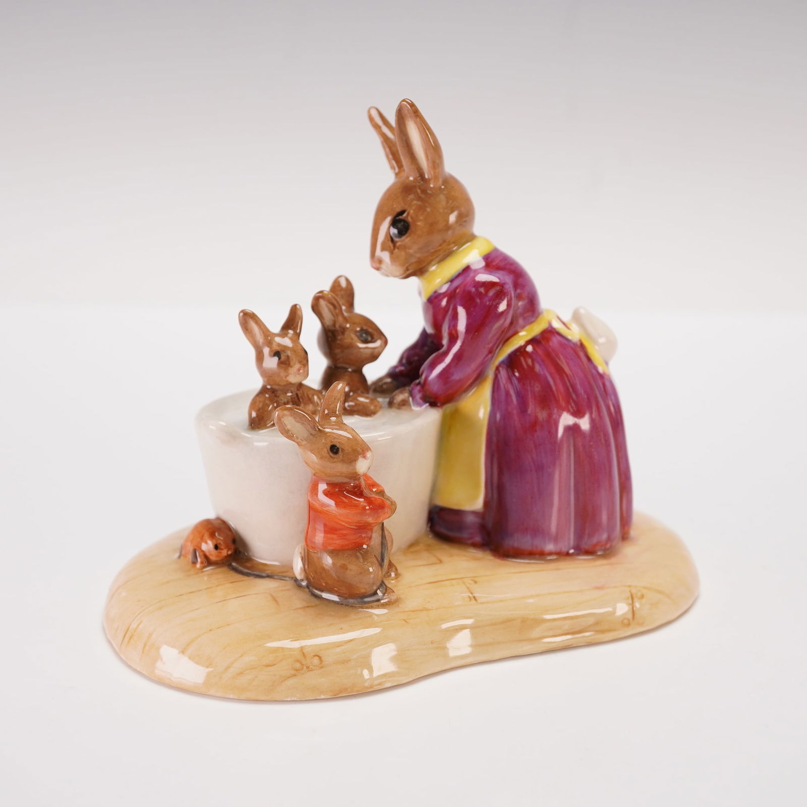 Royal Doulton Bunnykins Prototype Design Original Sample, Bath Night DB241: Charming Royal Doulton Bunnykins prototype figurine titled Bath Night, depicting a mother rabbit bathing her young ones in a white tub while another waits nearby wrapped in a red towel. Finely modeled
