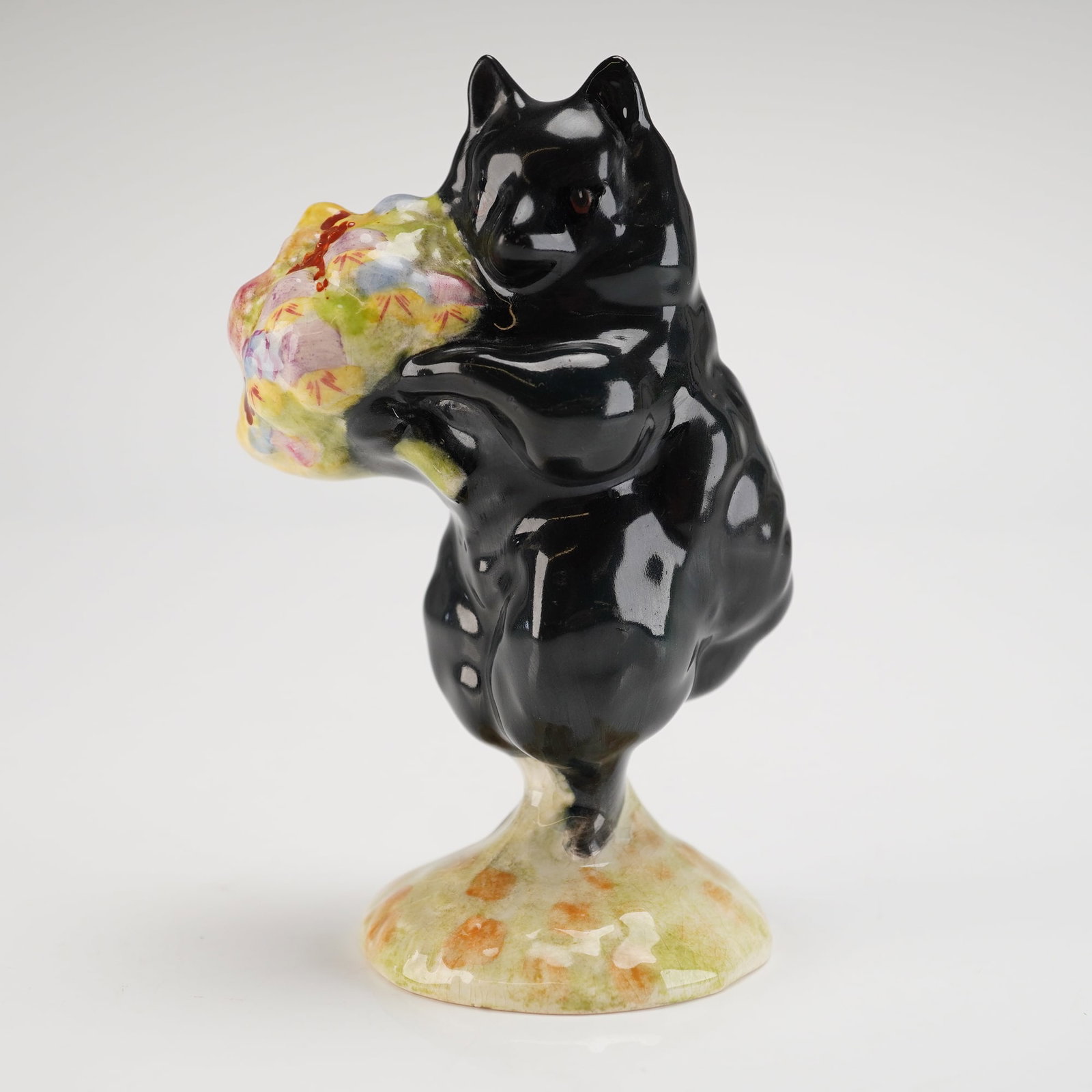 Rare Beswick Beatrix Potter's Figurine, Duchess Holding Flowers: Model number P1355, portraying Duchess, a character from Beatrix Potter's stories. The figure depicts an upright black dog holding a colorful floral bouquet, finished in a high-gloss black glaze. She