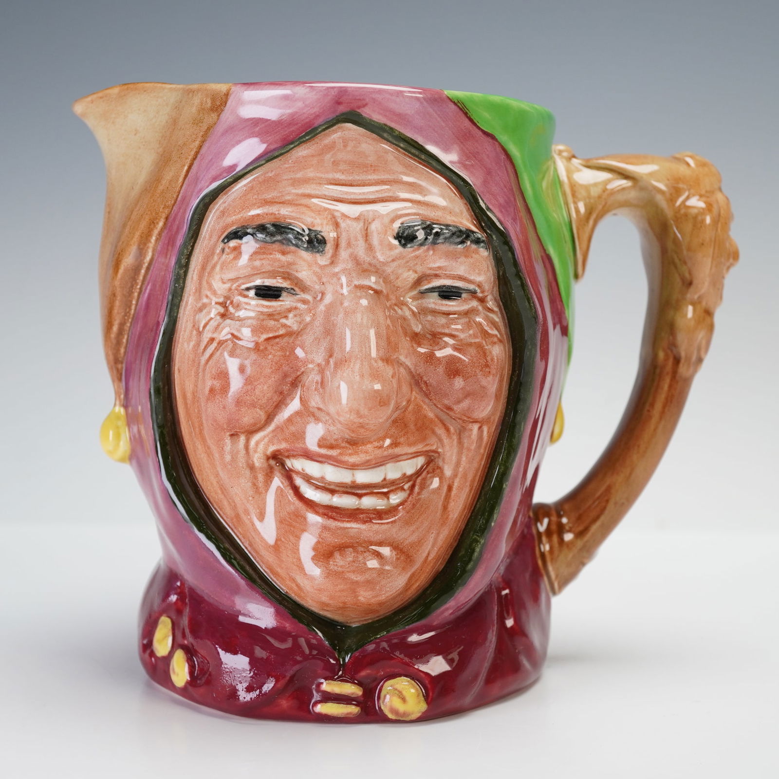 Royal Doulton Large Character Jug, Touchstone D5613: Royal Doulton large character jug depicting Touchstone, the court jester from Shakespeare's As You Like It, model number D5613. Designed by Charles Noke and Harry Fenton, this example shows Touchstone