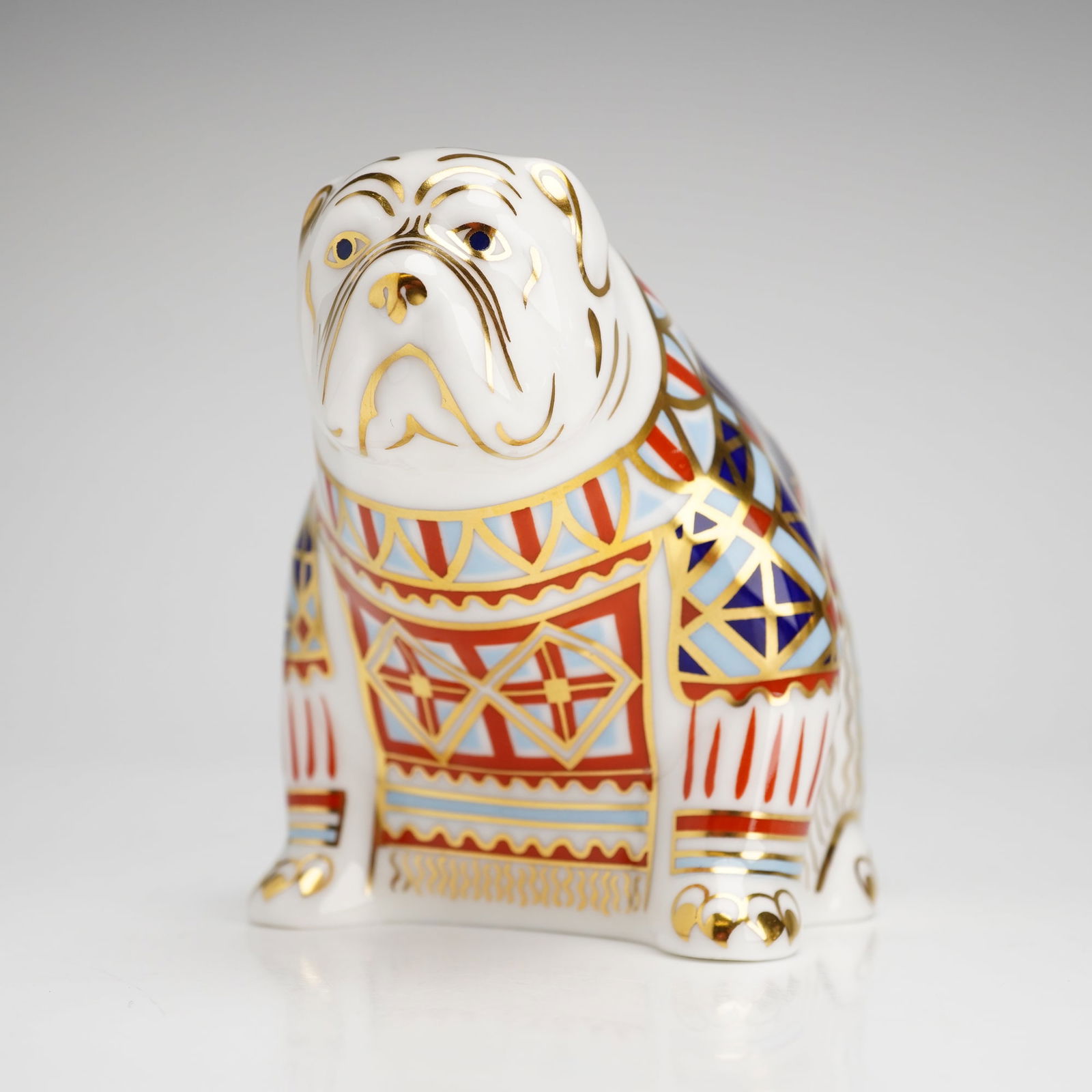 Royal Crown Derby Paperweight, Bulldog: A Royal Crown Derby bulldog, specially commissioned by Harrods as a limited edition. The figurine is decorated in a traditional Imari style, featuring intricate geometric and foliate patterns in cobal