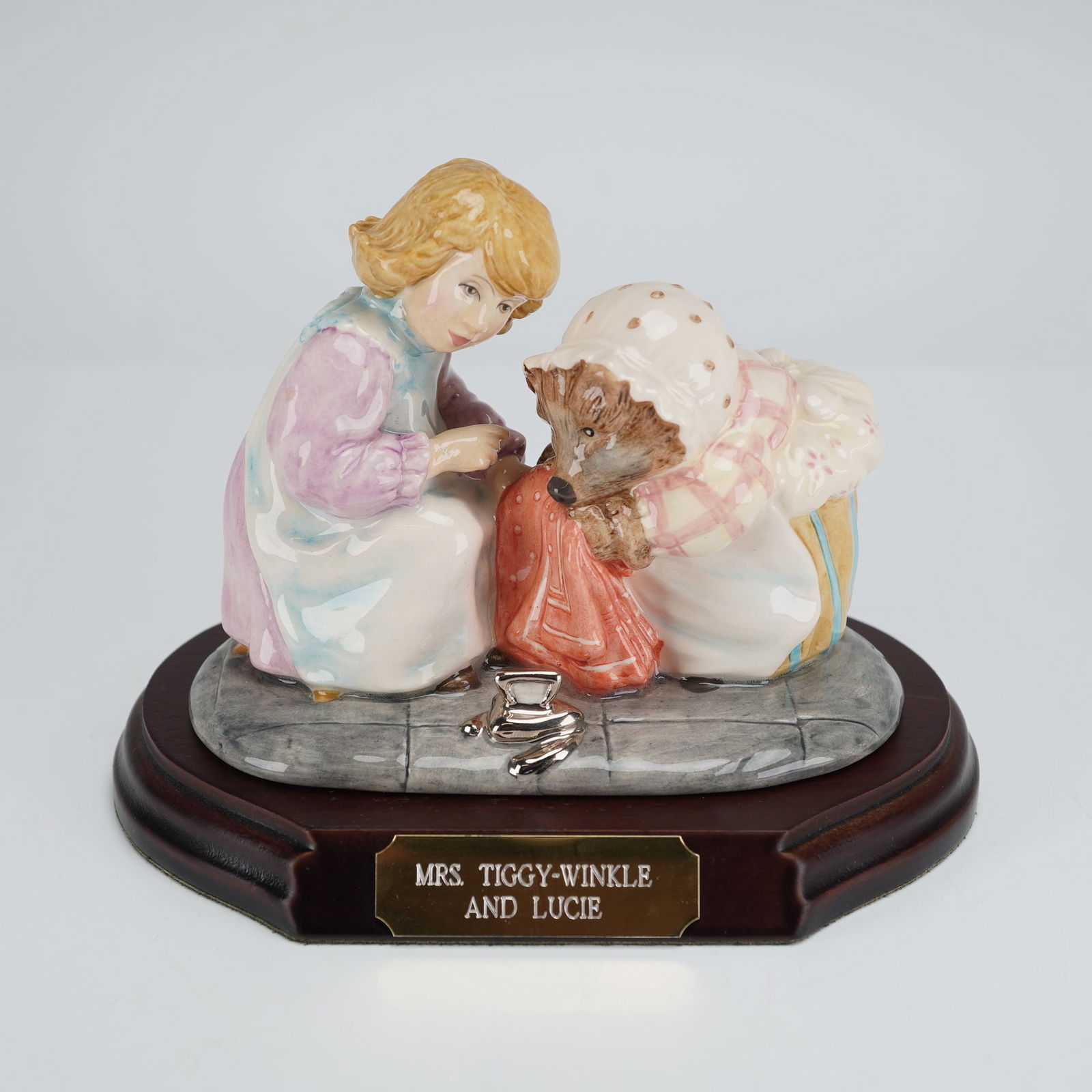 Beswick Beatrix Potter's Figurine, Mrs. Tiggy-Winkle and Lucie: Beswick Beatrix Potter Figurine, Mrs. Tiggy-Winkle and Lucie, limited edition from the "Peter Rabbit and Friends" collection. The tableau depicts Mrs. Tiggy-Winkle in a brown, pink, and cream dress wi