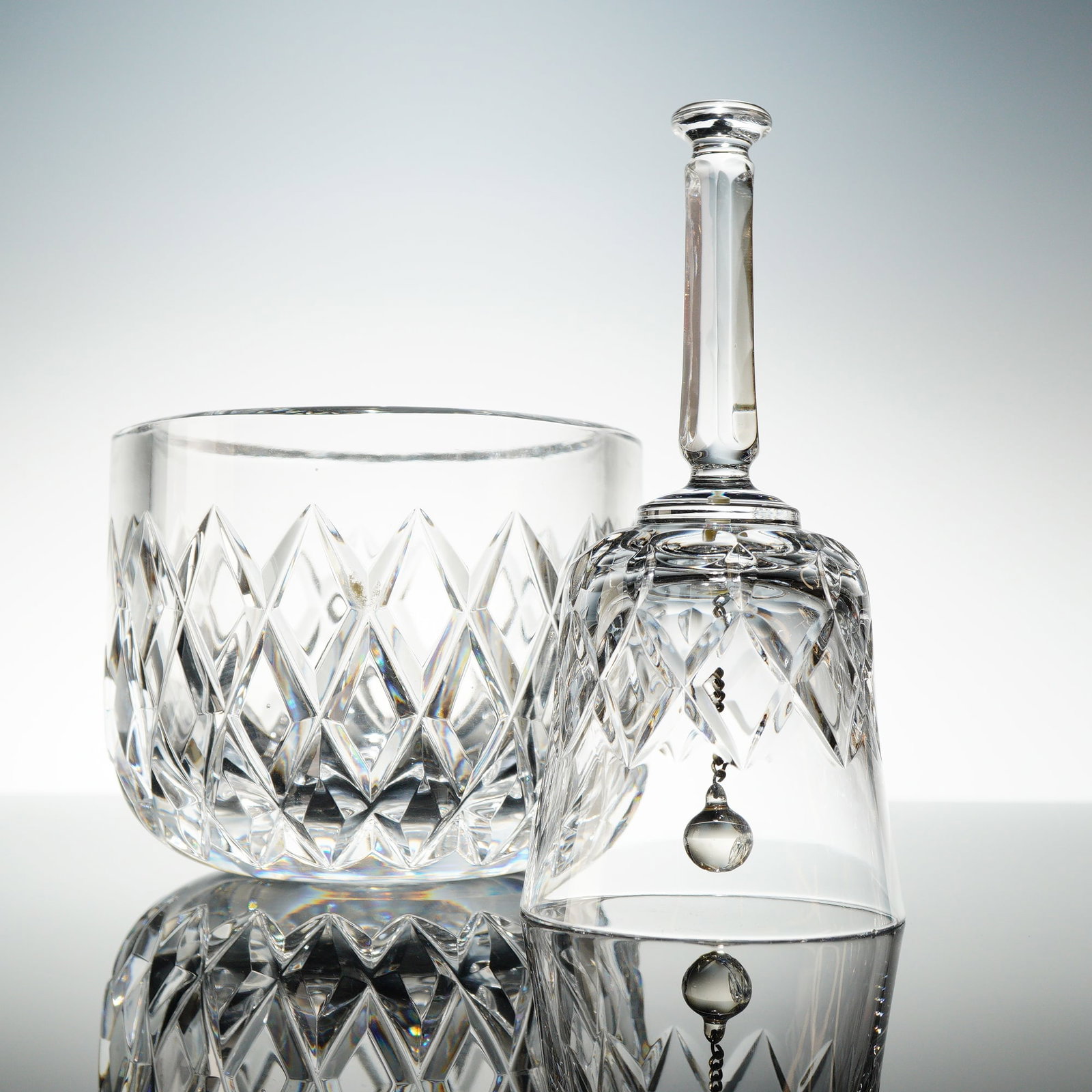 2pc Orrefors Crystal Bowl and Bell: The large, rounded bowl is decorated with deep, brilliant facet cutting in a uniform diamond or crisscross patern. The dinner bell has same cut design with undecorated stem. Orrefors etched makers mar