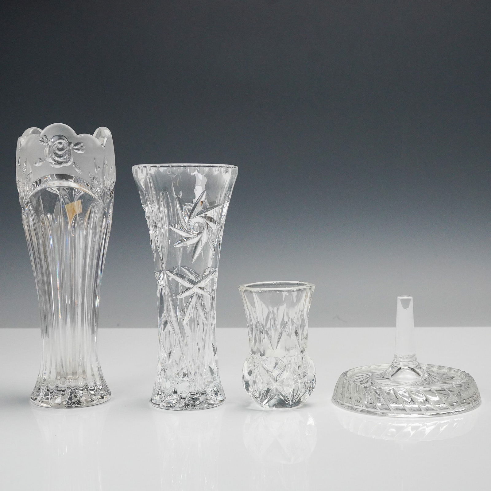 4pc Crystal Vase, Toothpick Holder & Ring Stand Collection: Collection of four clear glass and crystal pieces including a range of decorative and functional forms. The group features a Oneida German lead crystal vase with a scalloped rim and frosted floral mot
