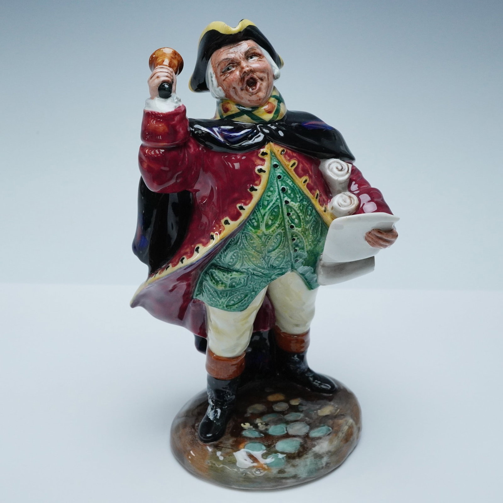 Royal Doulton Figurine, Town Crier HN2119: Classic Royal Doulton figurine titled "Town Crier," model HN2119. Issued in 1952 and hand-decorated in vibrant 18th-century attire, the figure raises his bell and scroll in mid-announcement. Marked to