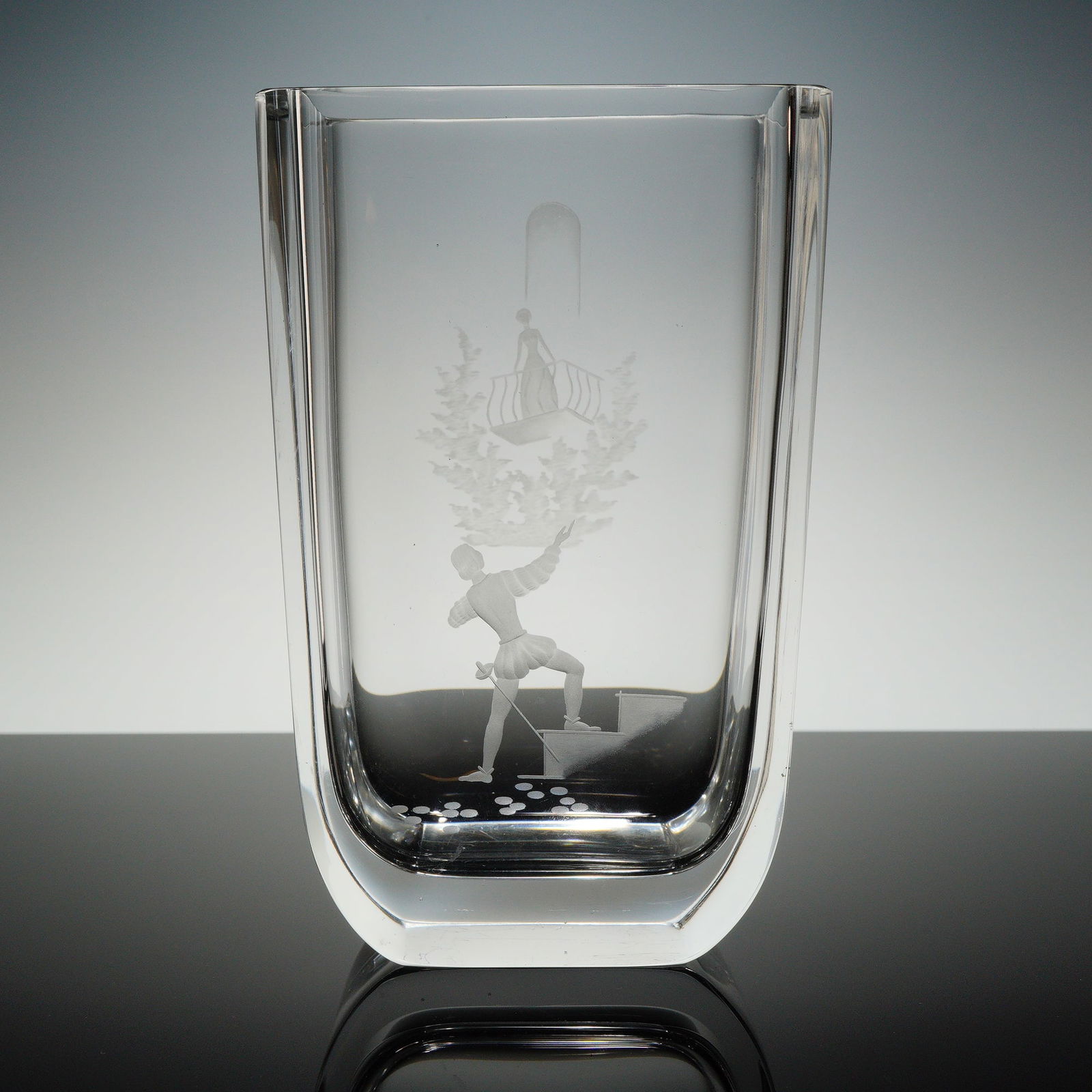 Orrefors Etched Crystal Romeo and Juliet Vase: The vase is made of heavy crystal and cut with the balcony scene of Romeo and Juliet. Base refi?ects Orrefors etched makers mark. Dimensions: 3.00"L x 5.00"W x 8.00"H
