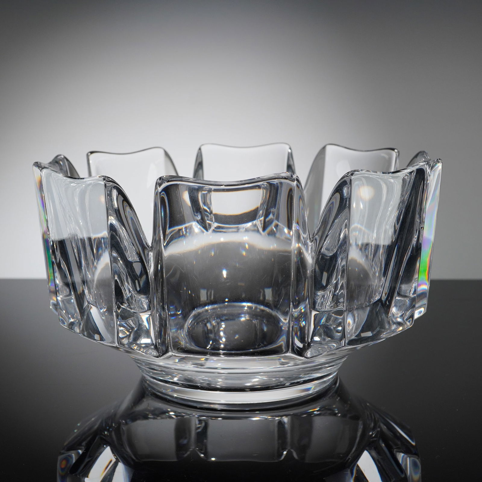 Orrefors Crystal Bowl: Crystal bowl composed of clear lead crystal. The object features complex faceting visible on the upper portion and a polished footed base. The base is hand-etched or engraved with the Orrefors signatu