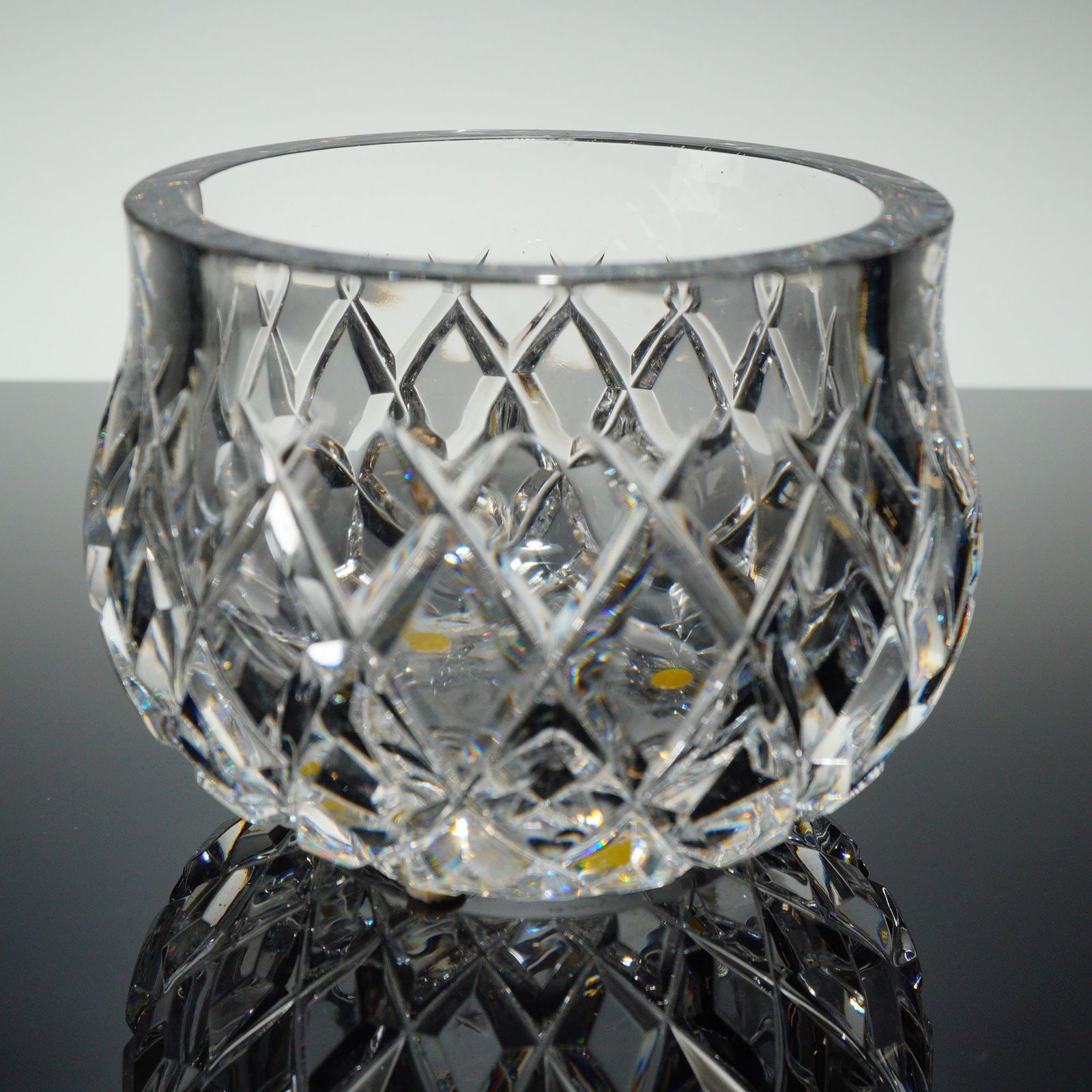 Orrefors Sofiero Cut Crystal Bowl: A single Orrefors Sofiero Crystal Bowl constructed of heavy, clear lead crystal or high-quality cut glass. The short, globular vessel is executed in the Brilliant Cut style, featuring deep, all-over e