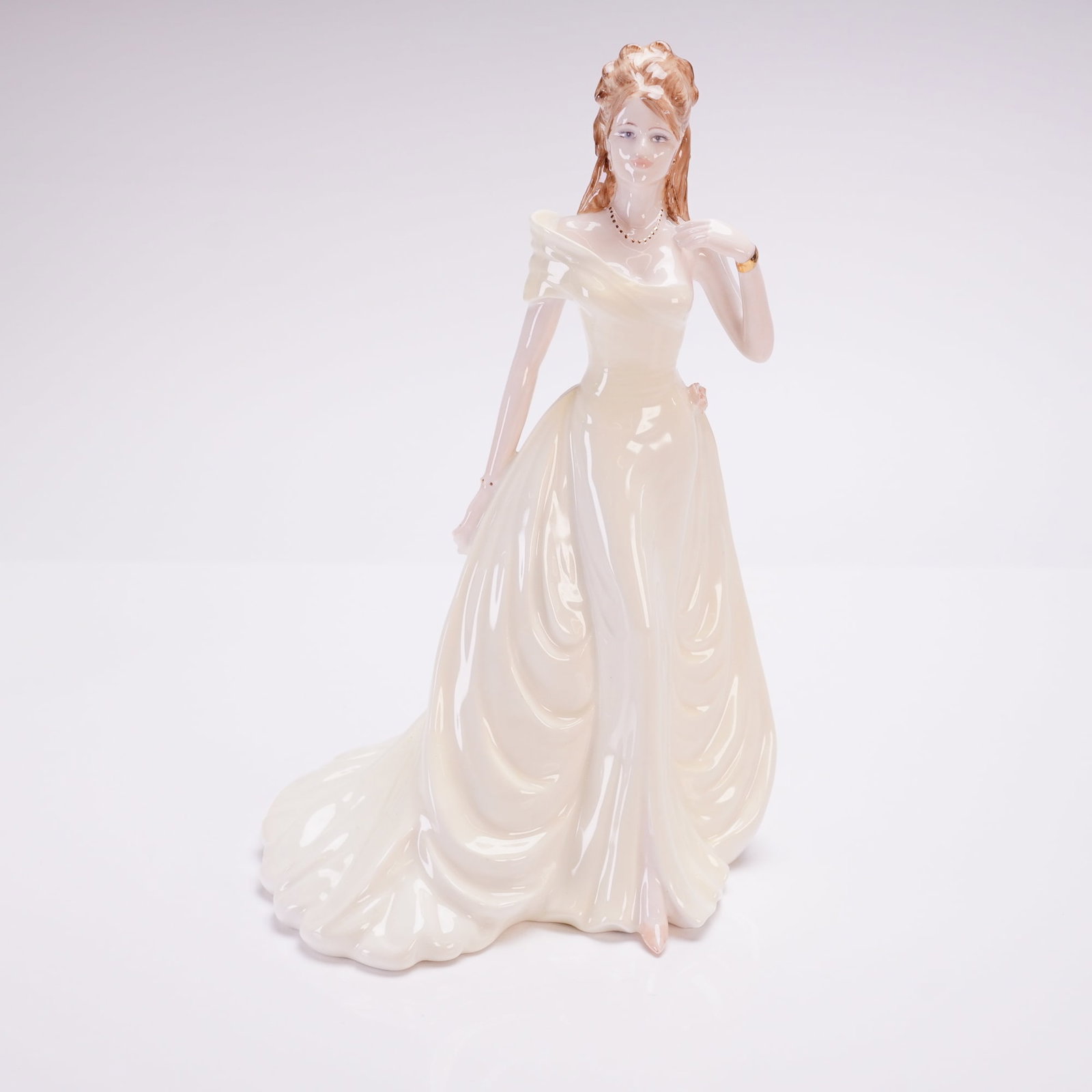 Coalport Figurine Ladies of Fashion Figurine, Susan: Figurine was modeled by Jack Glynn and hand-decorated in England, the piece depicts a female figure in a cream-colored off-the-shoulder evening gown with a full skirt. The hair is styled in a formal u