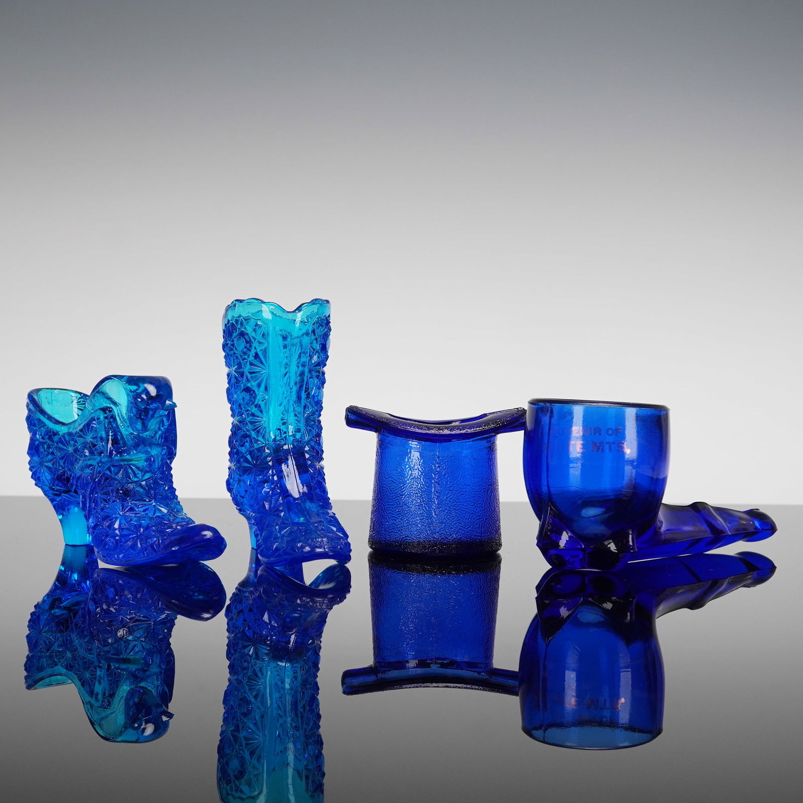 4 Cobalt & Aqua Pressed Glass Daisy & Button Whimsies: A collection of four novelty pressed glass items, commonly associated with Early American Pattern Glass (EAPG) whimsies, executed primarily in deep cobalt and brilliant aqua blue glass. The collection