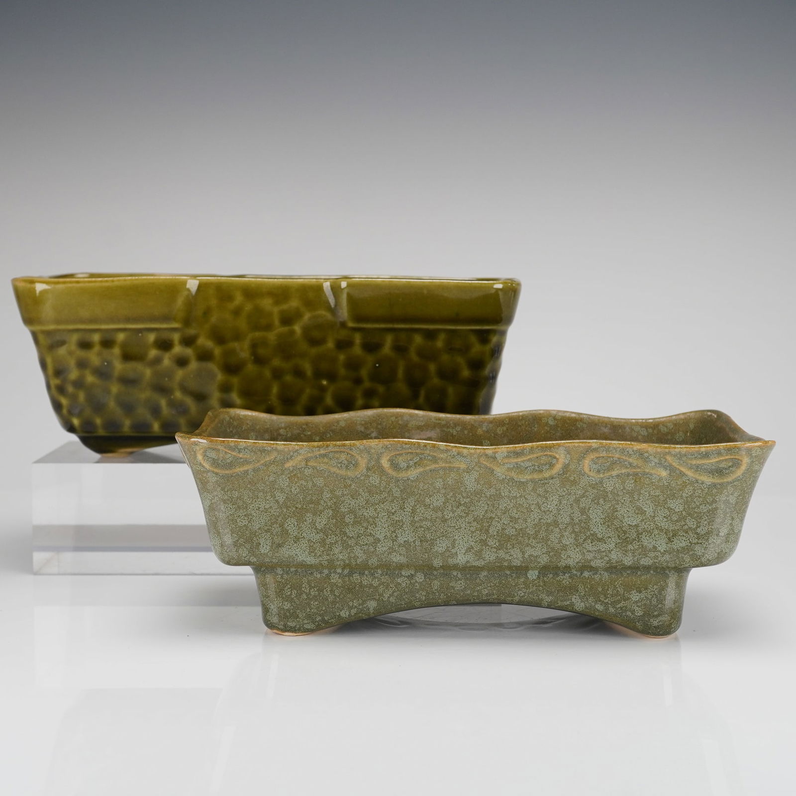 A Pair of Brush McCoy Green Glazed Ceramic Rectangle Planters: A pair of vintage Brush McCoy green glazed ceramic rectangle jardinieres. The collection features two distinct rectangular trough-form planters. The first planter is finished in a glossy, dark olive-g