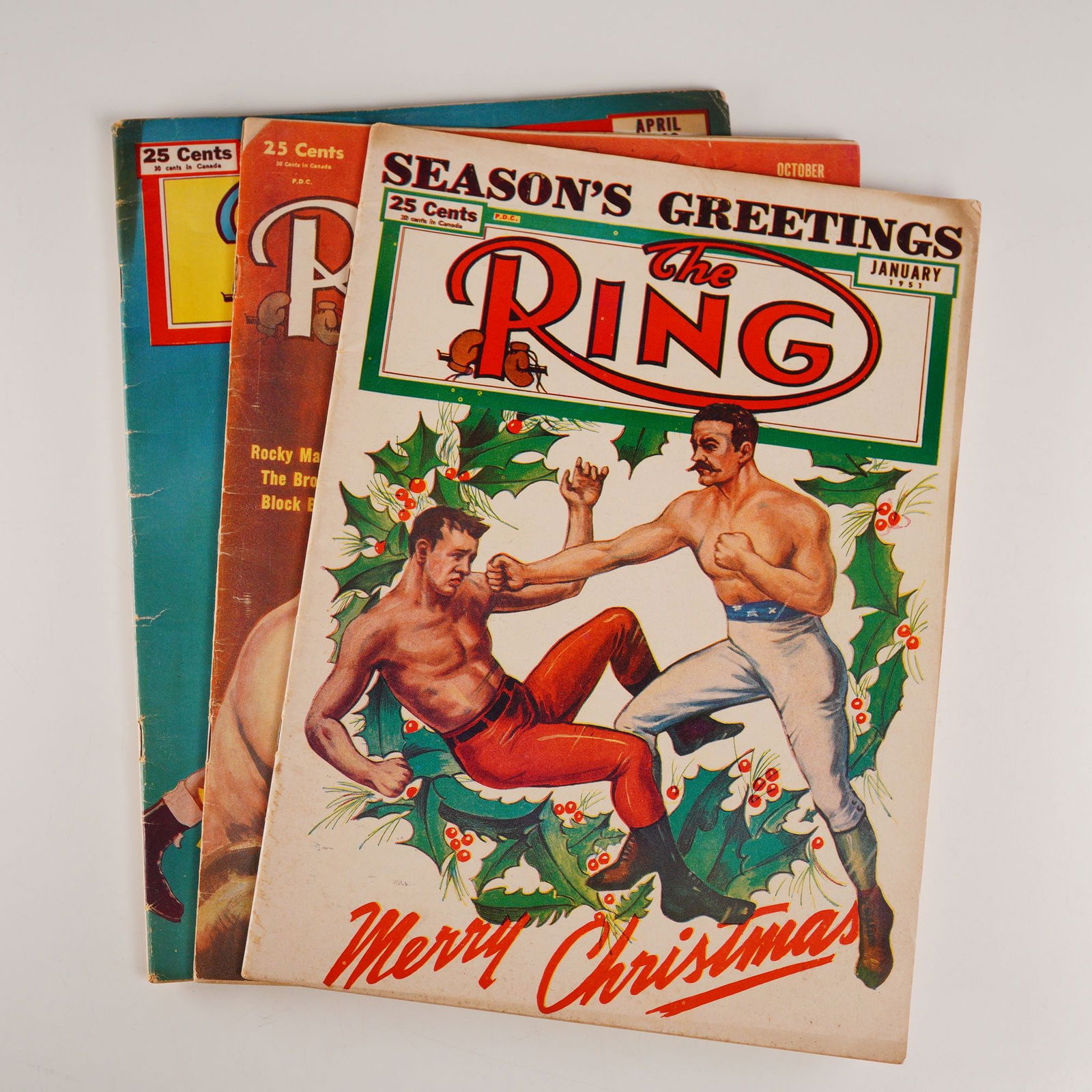 3pc Mid-20th Century Boxing Magazines, The Ring: Set of three vintage The Ring boxing magazines from years 1949, 1952, and 1953 featuring the article Irish Eyes on Maxim's Title by Nat Loubet, cover art of Louis vs. Dempsey, and the January issue wi