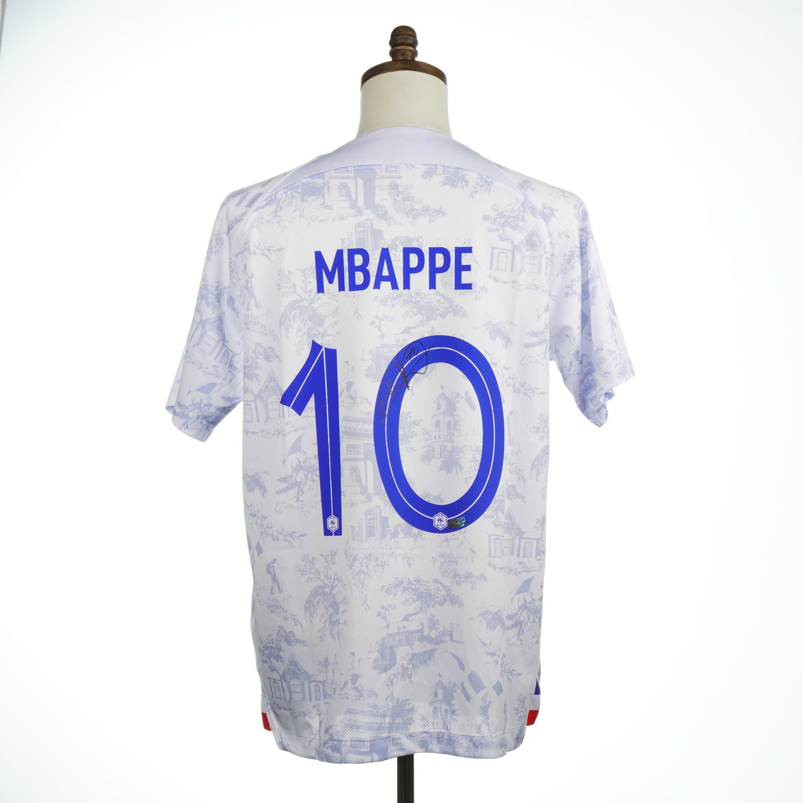Kylian Mbappe Autographed 2022 France National Team Home Jersey Panini: A trio of items comprising an autographed Kylian Mbappe 2022 France National Team Authentic White Home Jersey, a Panini Authentic Certificate of Authenticity (COA), and a Panini branded envelope. The