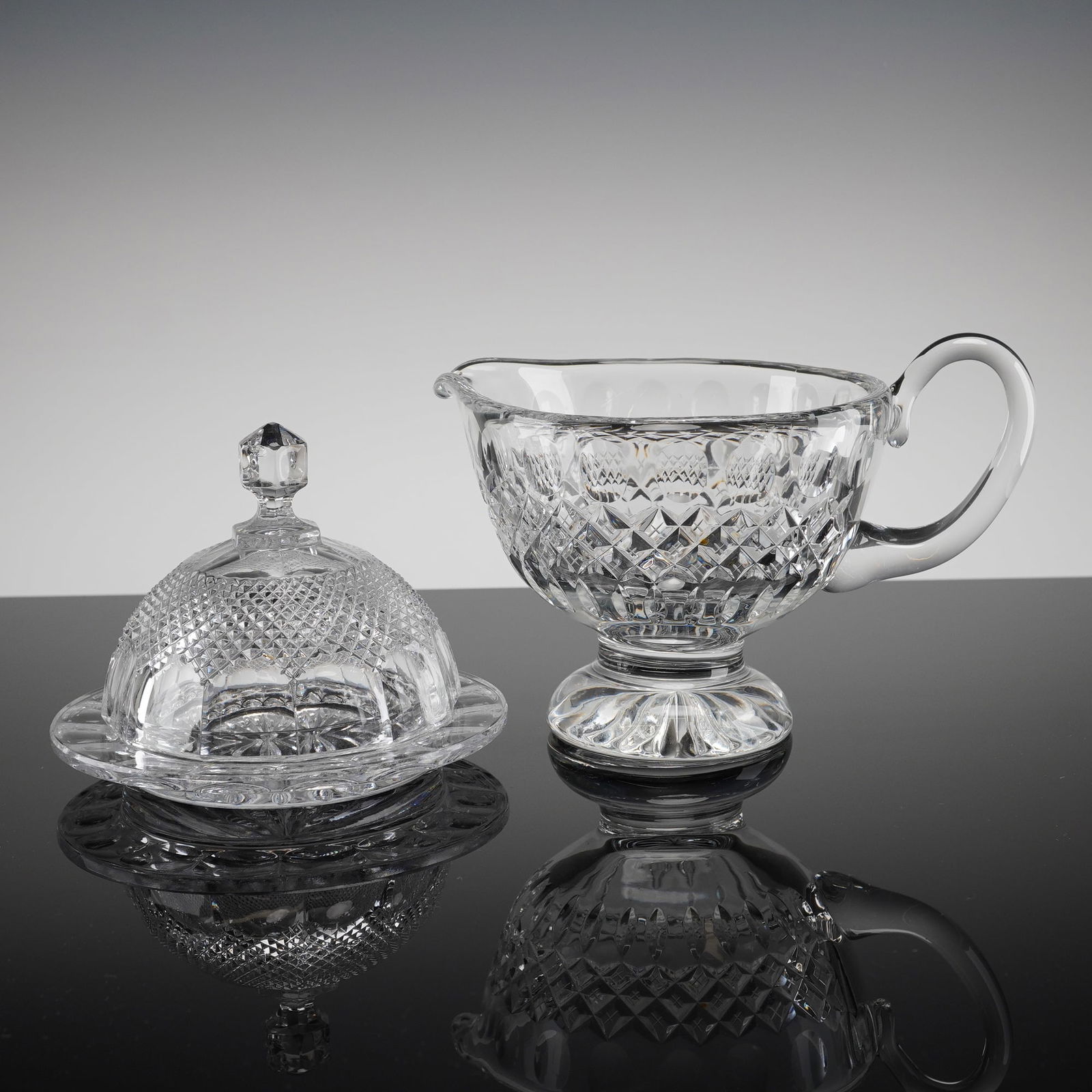 Three Anchor Hocking Wexford Cryst. Serving Pieces incl. Sauce Server: A trio of clear pressed glass serving pieces in the Anchor Hocking Wexford pattern. The collection includes a footed, handled crystal sauce server, and a two-piece covered butter dish ensemble. The sa