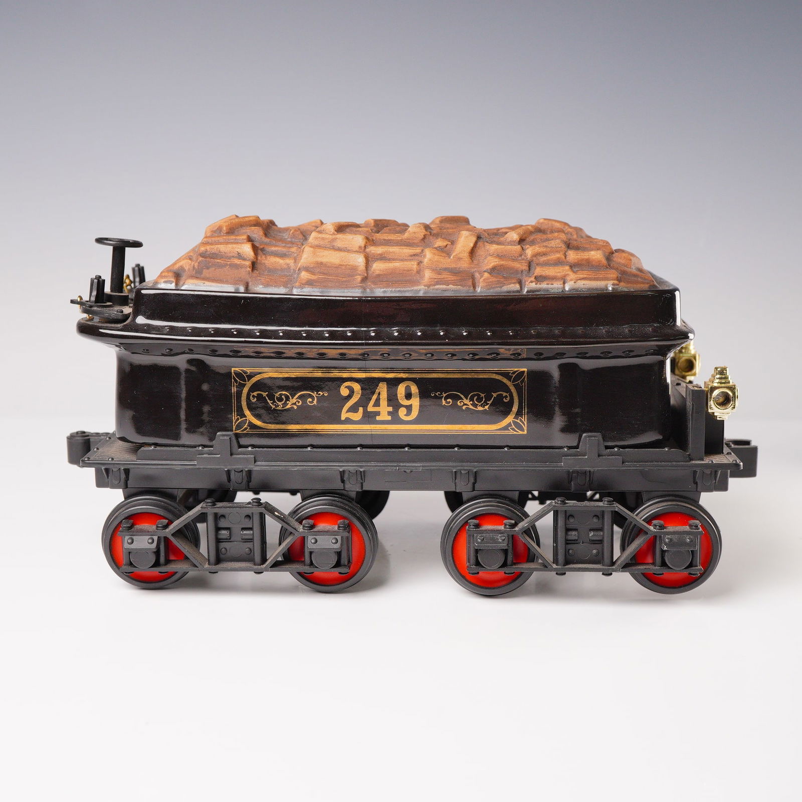 Jim Beam #249 Coal Tender Train Decanter 1982: A novelty liquor decanter produced by the Regal China Corporation for the Jim Beam Distilling Co. in 1982, modeled as a steam locomotive coal tender car designated "249." The body is constructed of bl