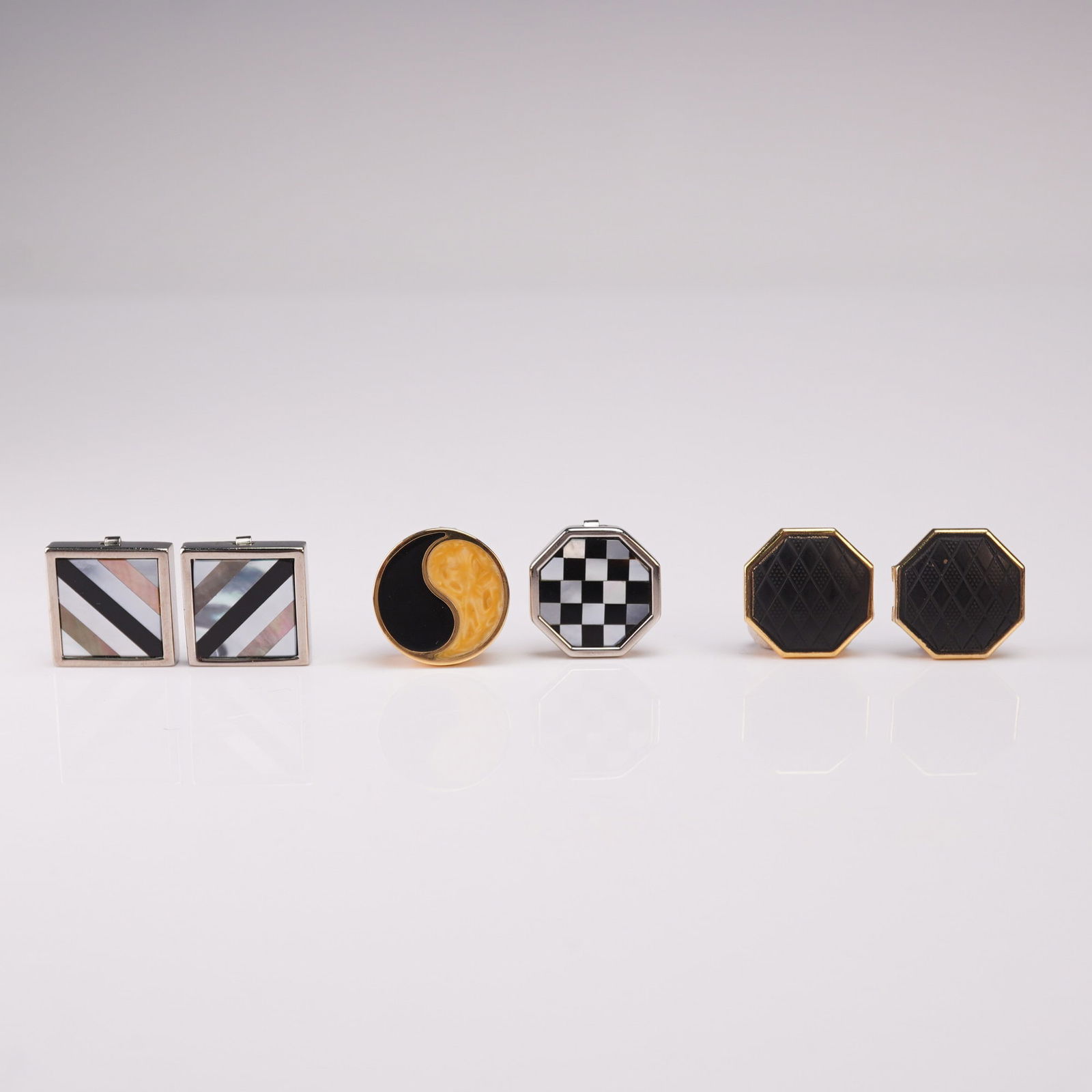 3 Pairs of Art Deco Inspired Geometric Button Covers: An eye-catching trio of button covers, each featuring bold geometric designs and vibrant inlays. The collection includes one pair with square silver-tone frames set with diagonal stripes of mother of