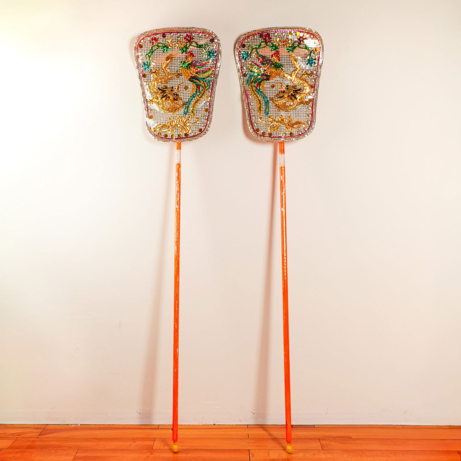 Pair of Chinese Embroidered Festival Shields with Dragon and Phoenix: A magnificent pair of embroidered ceremonial festival shields, originating from Guangdong, China. Each shield is elaborately adorned with vibrant sequins and beadwork, featuring the timeless pairing o