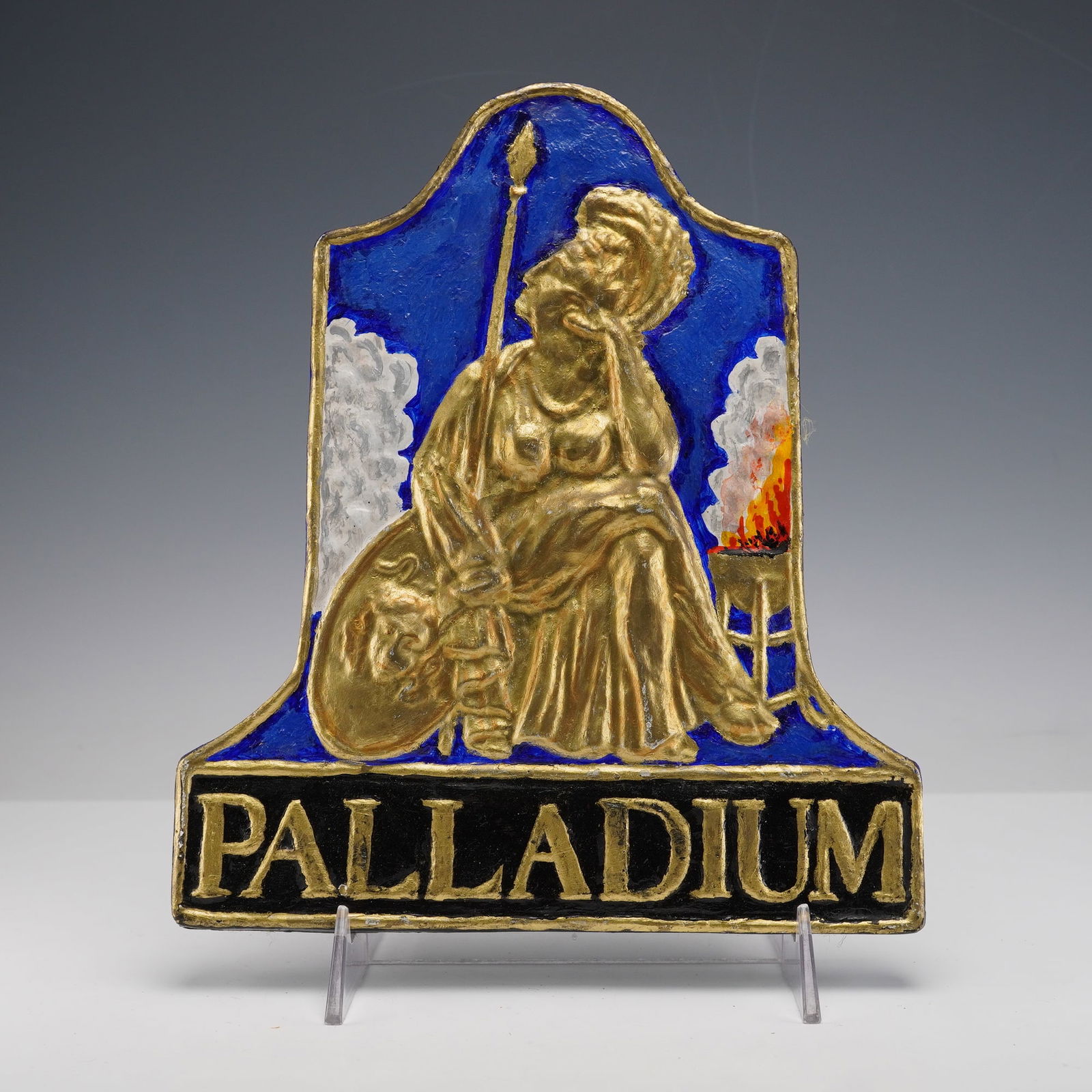 Palladium Insurance by E. V. Jackson Reproduction Fire Mark Plaque: This plaque shows a raised gold colored figure of Pallas Athena seated with a spear and shield against a deep blue background with smoke and fire details on each side. The bottom panel reads Palladium