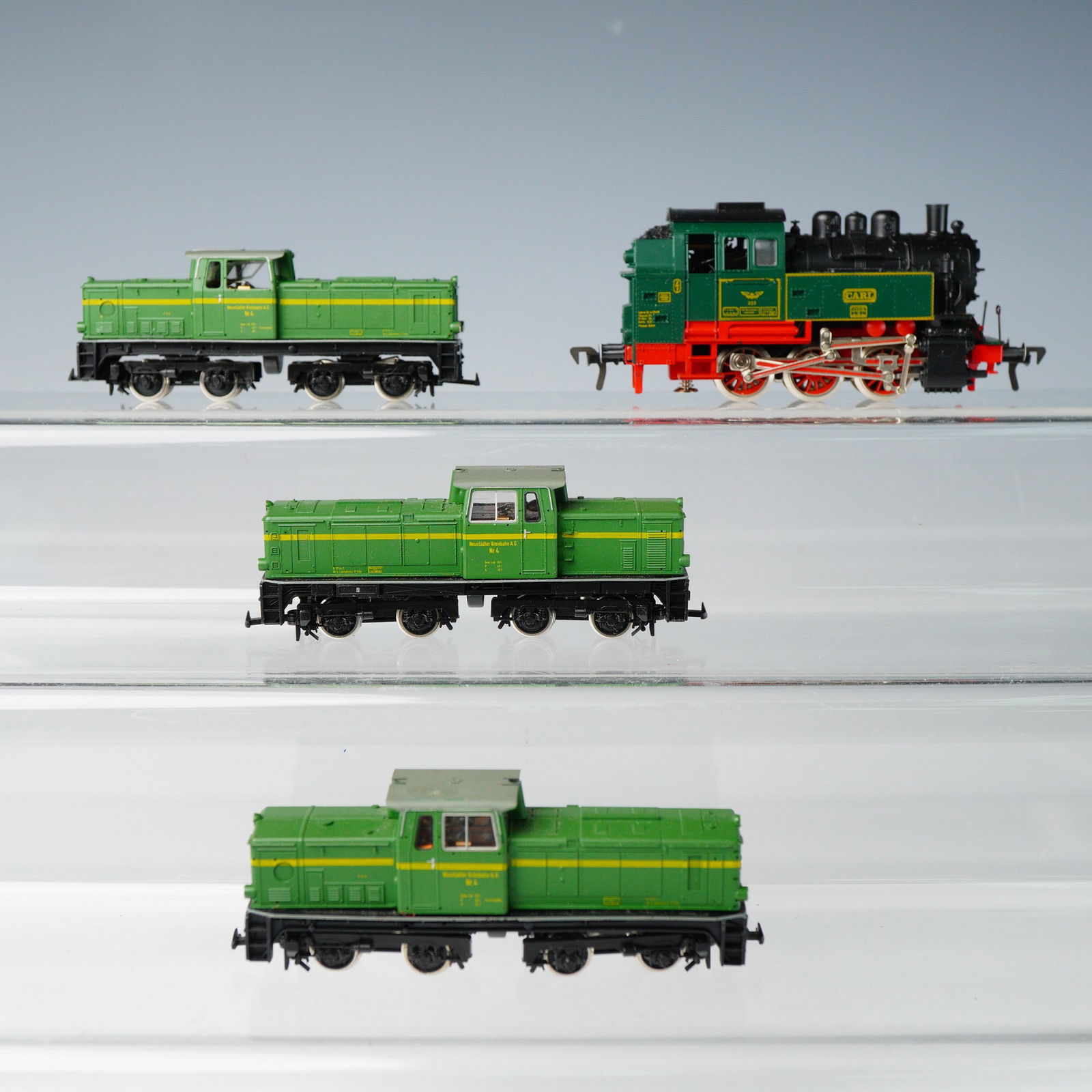 4pc H0 Scale German Model Locomotives: A collection of four H0 scale model train locomotives depicting German prototypes, constructed primarily from plastic and metal components. The collection includes one steam tank locomotive and three