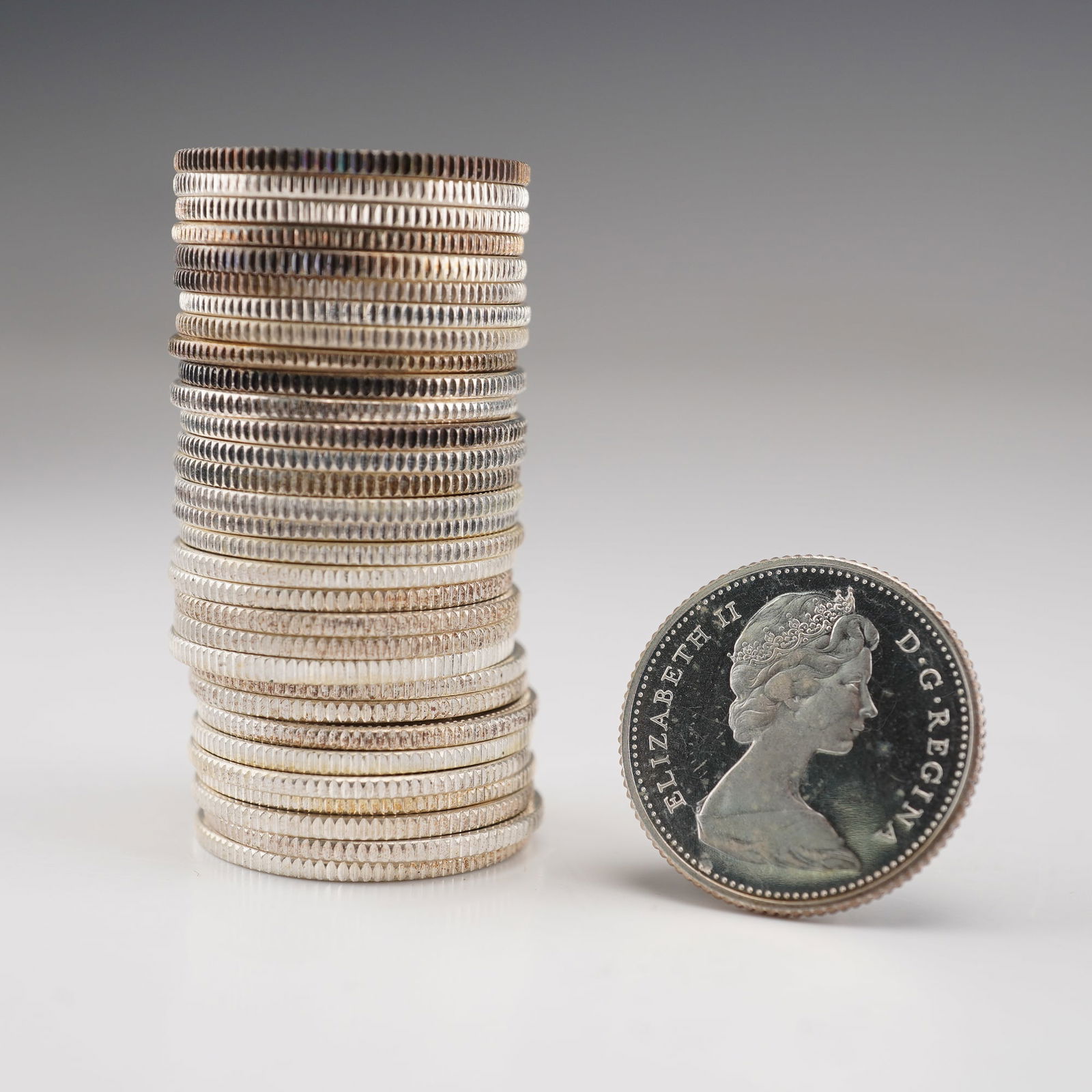 32pc 1962 & 1966 Canada Elizabeth II 10 Cent Coins: Includes four 1962 Elizabeth II 1st portrait obverse and twenty-eight Elizabeth II second portrait obverse. Each reverse depicts the Bluenose under sail, a Canadian schooner from Nova Scotia, a celebr