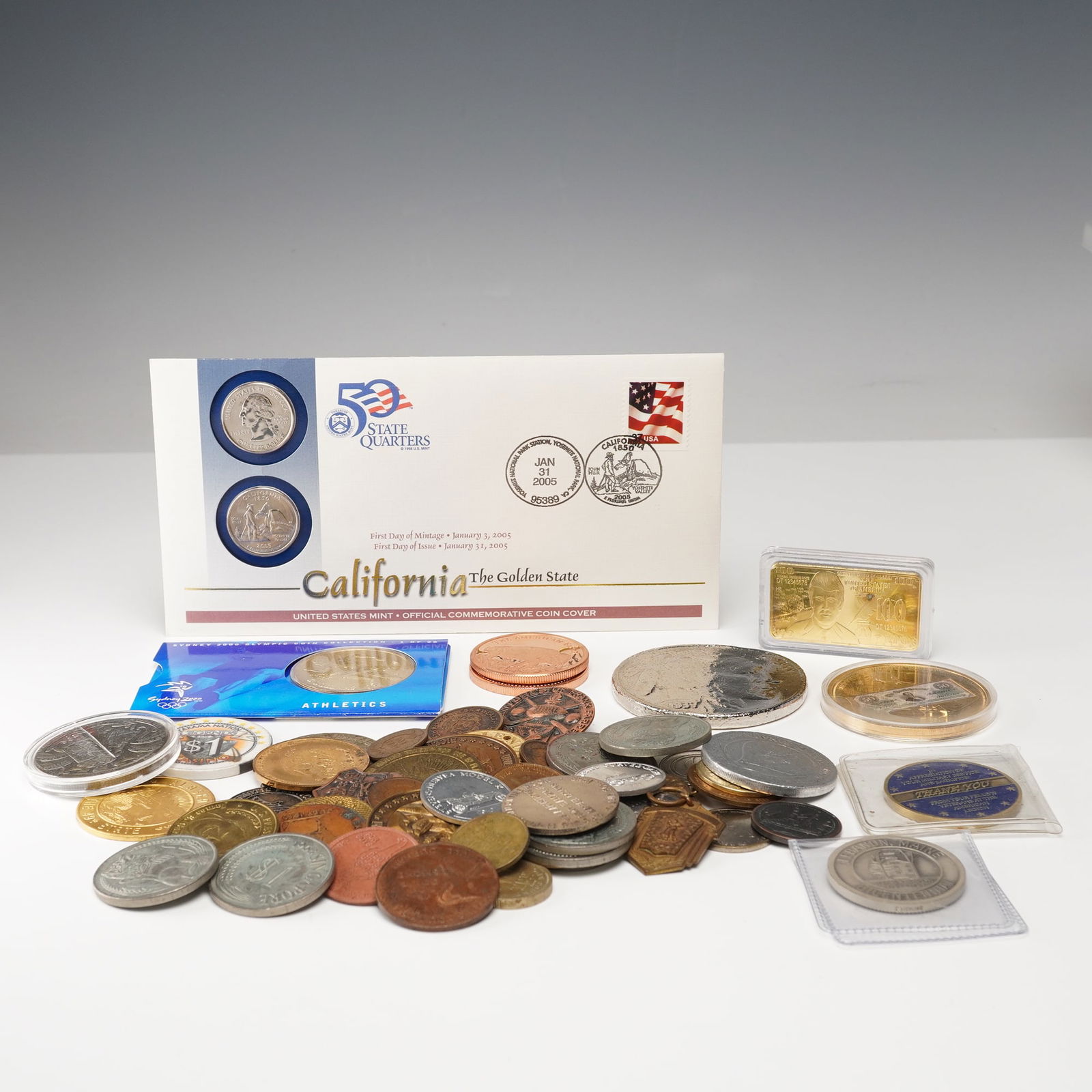 Large Collection of Coins, Medals, Tokens, and Chips: This lot features a diverse collection of coins, medals, tokens, and chips, including items such as U.S. State Quarters (e.g., California 2005), commemorative tokens (such as Lebanon, Maine and NASA-t