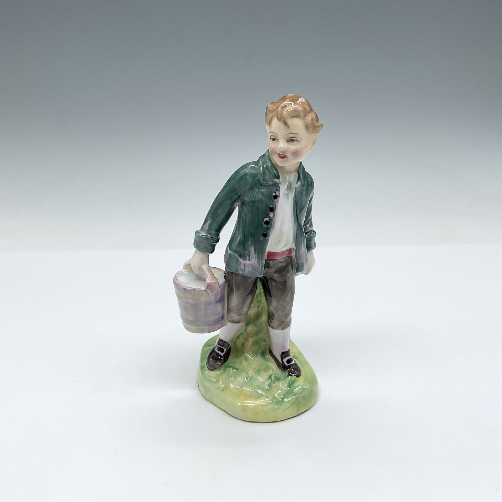 Jack - HN2060 - Royal Doulton Figurine: Figure from Jack and Jill, is part of Nursery Rhymes Series One, carrying a pail of water, colored in green, white and black. Royal Doulton backstamp Artist: Leslie Harradine Issued: 1950 - 1971
