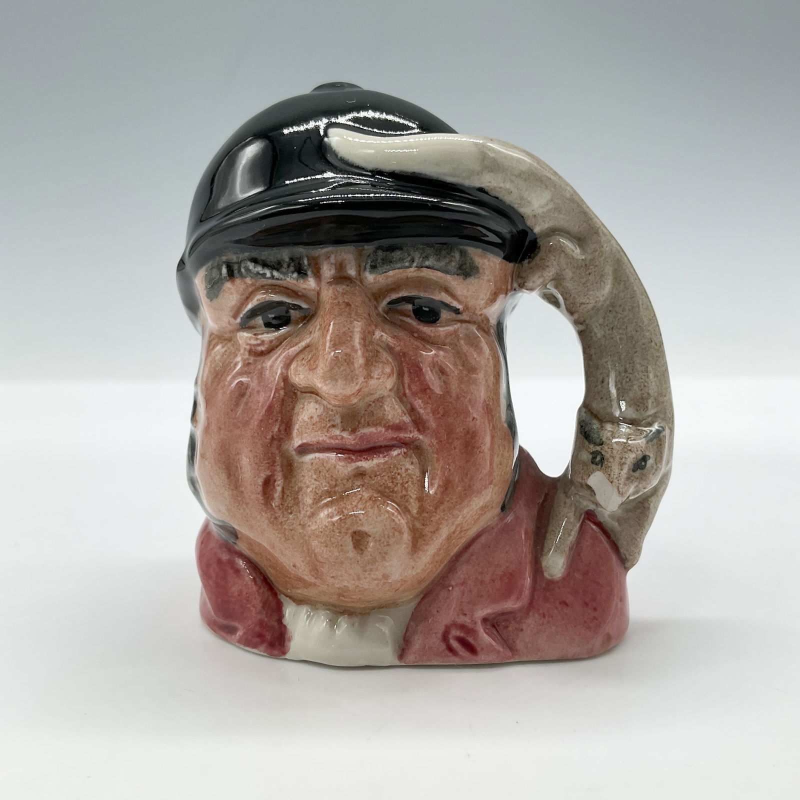 Gone Away D6545 - Mini - Royal Doulton Character Jug: Red jacket; black cap. Royal Doulton backstamp. Artist: Garry Sharpe Issued: 1960 - 1982 Dimensions: 2.5"H Country of Origin: England