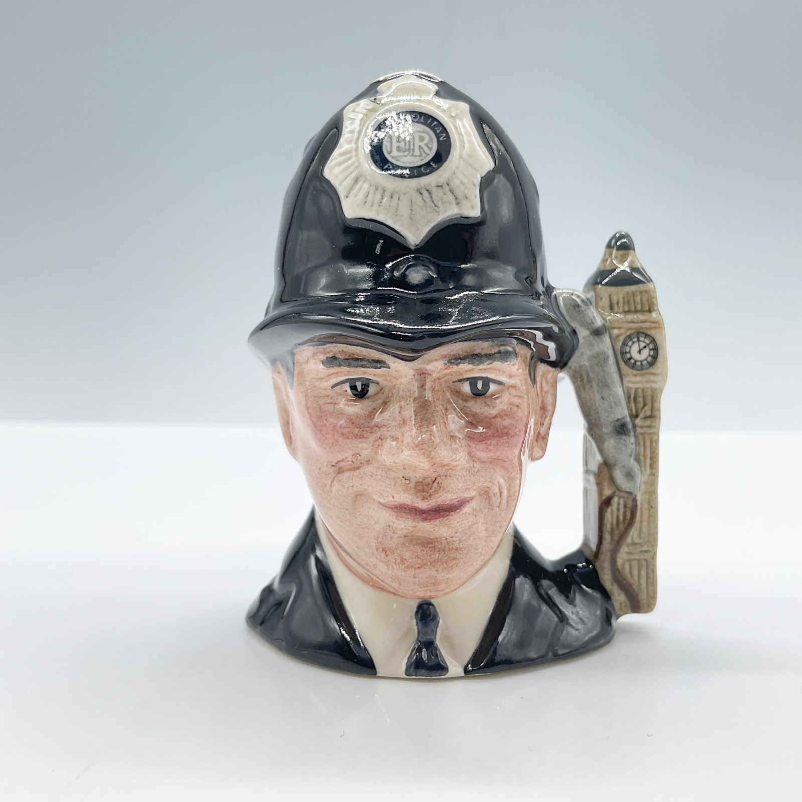 London Bobby D6763 (Embossed) Mini Doulton Character Jug: Royal Doulton backstamp. Artist: Stanley J. Taylor Issued: 1987 - 1987 Dimensions: 2.5"H Country of Origin: England