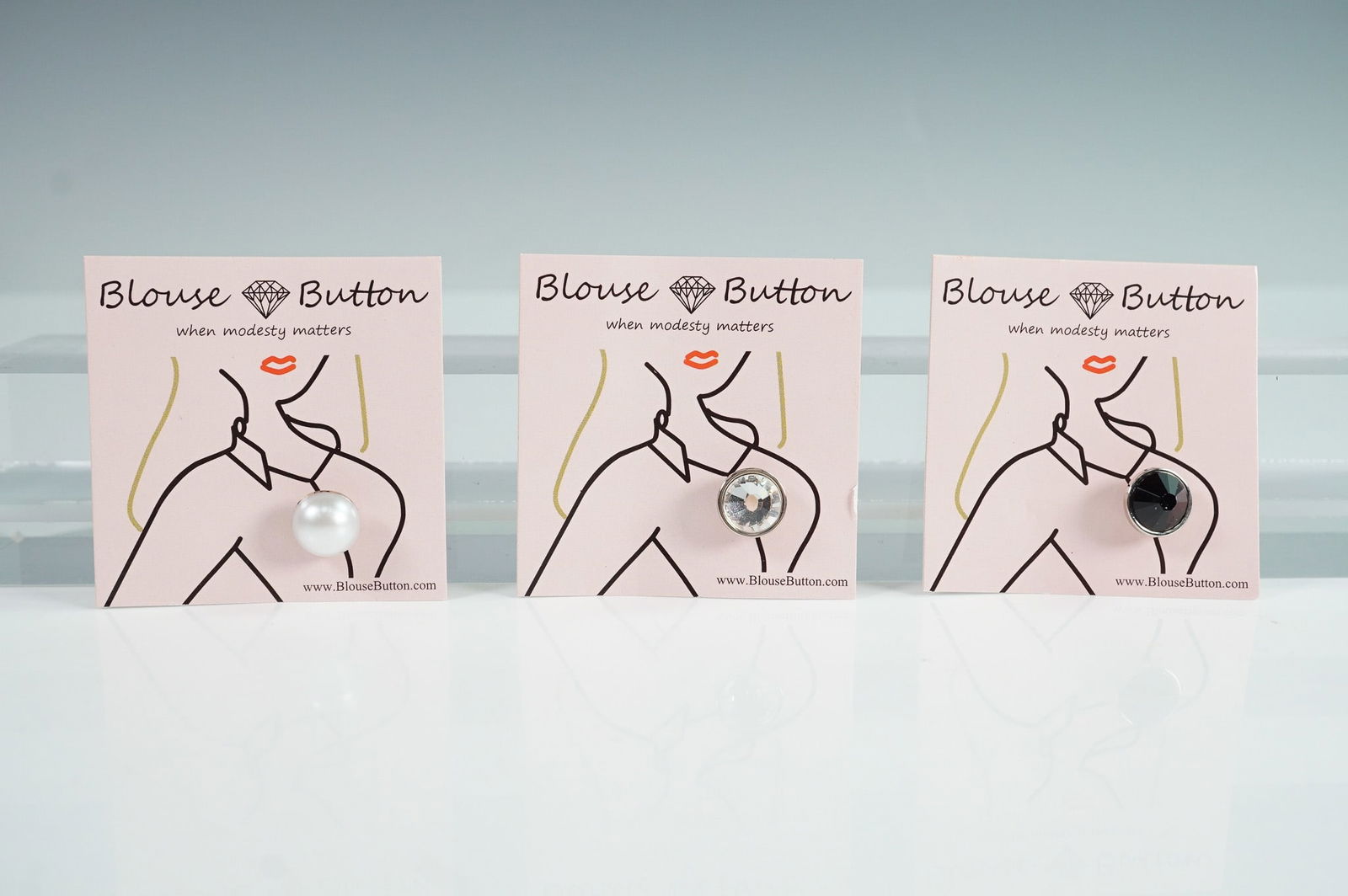 3pc BlouseButton Crystal, Jet Black & White Pearl Buttons: Set of three BlouseButton decorative fasteners, designed as functional fashion accessories to help secure wrap tops, low-cut blouses, or close shirt gaps. This set includes a round white faux pearl