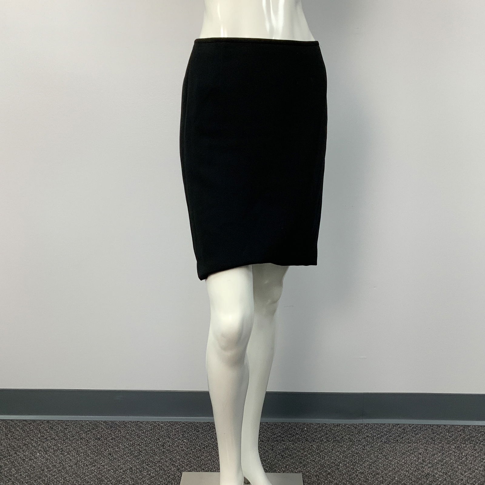 Elegant Black Pencil Skirt: A timeless black pencil skirt with a pleated detail on the back. Size: 12. Waist: 14"W. Full length: 19.25"L. All measurements are approximate. Issued: c. 1980 Dimensions: See Description