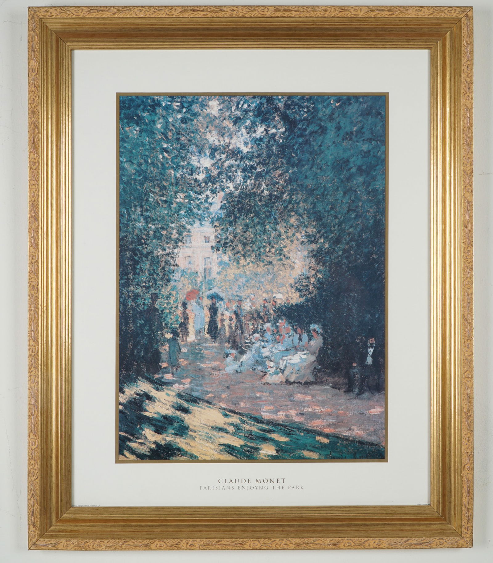 After Claude Monet, Reproduction Poster, Parisians Enjoying the Park: Framed color reproduction poster of Claude Monet's painting Parisians Enjoying the Park. The Impressionist scene shows figures gathered under a lush canopy of trees with dappled light and a path leadi