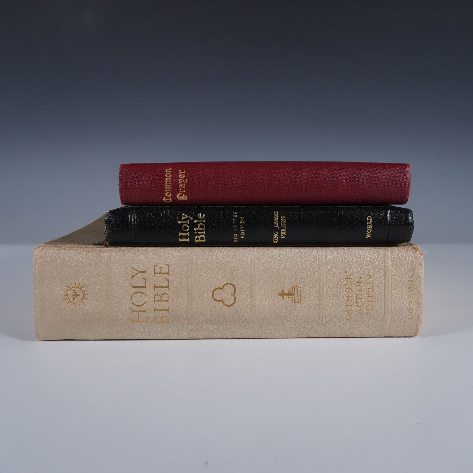 3 Vintage Bibles and Prayer Books, Ilustrated: This lot includes three vintage religious books: a large-format Catholic Action Edition of The Holy Bible published by Good Will Publishers, featuring the Confraternity and Douay-Challoner texts and i