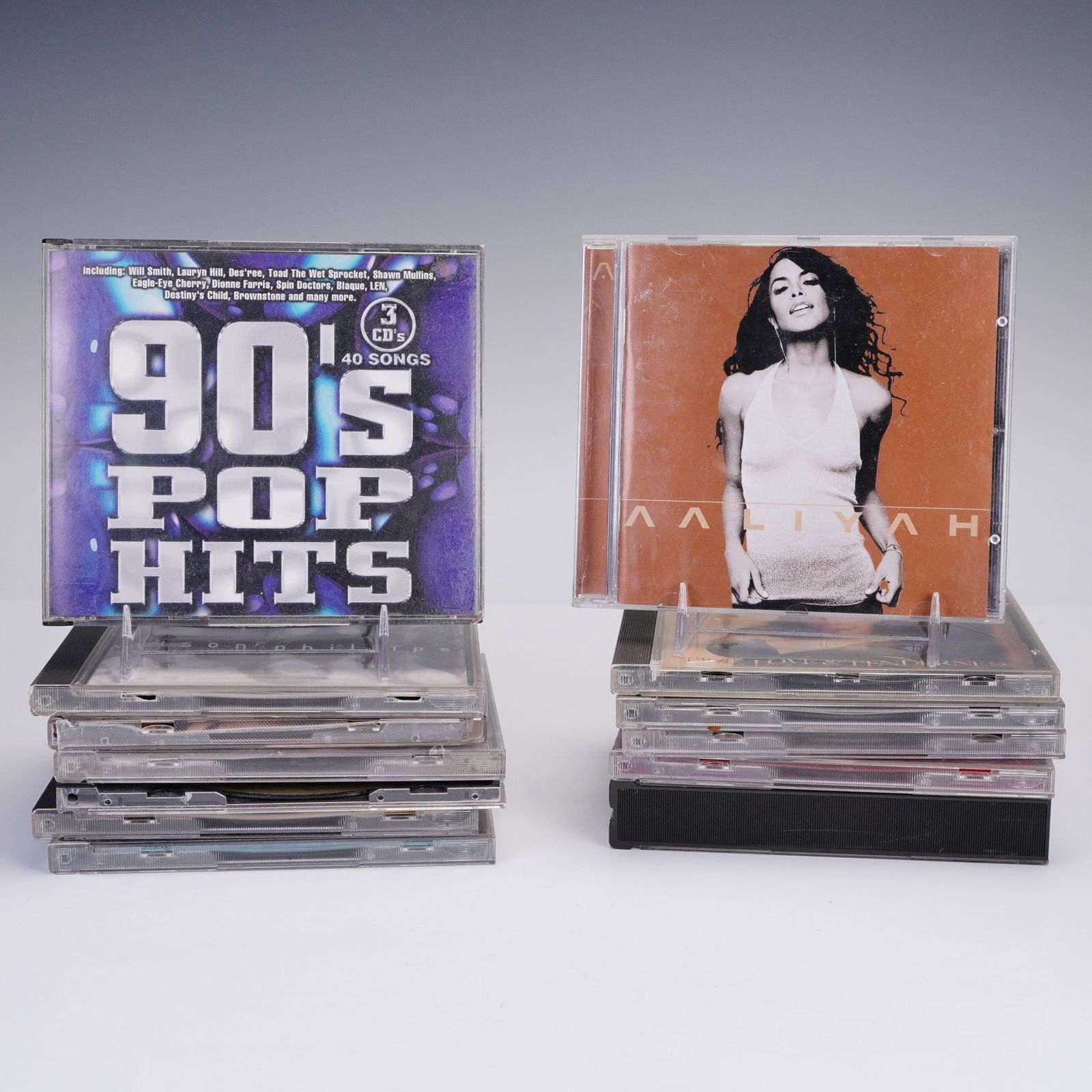 13pc 90s and Early 2000s R&B and Pop CD Collection: Collection of 13 CD albums featuring iconic R&B and pop artists from the 1990s and early 2000s. Includes albums by Aaliyah, Macy Gray, TLC, and Janet Jackson, along with compilation sets such as 90's