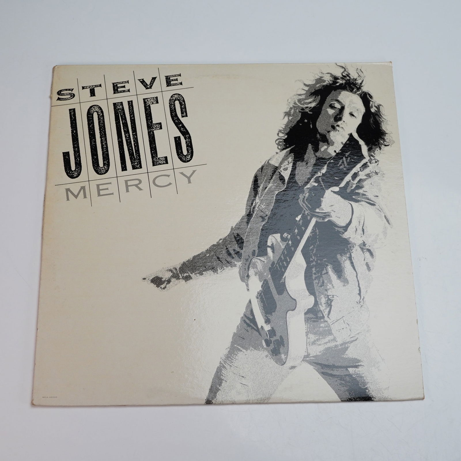 MCA Records Steve Jones Vinyl Record, Mercy: An original 1987 pressing of Mercy, the debut solo studio album by Steve Jones, issued by MCA Records. Known primarily as the guitarist for punk legends the Sex Pistols, Jones here departs from his an