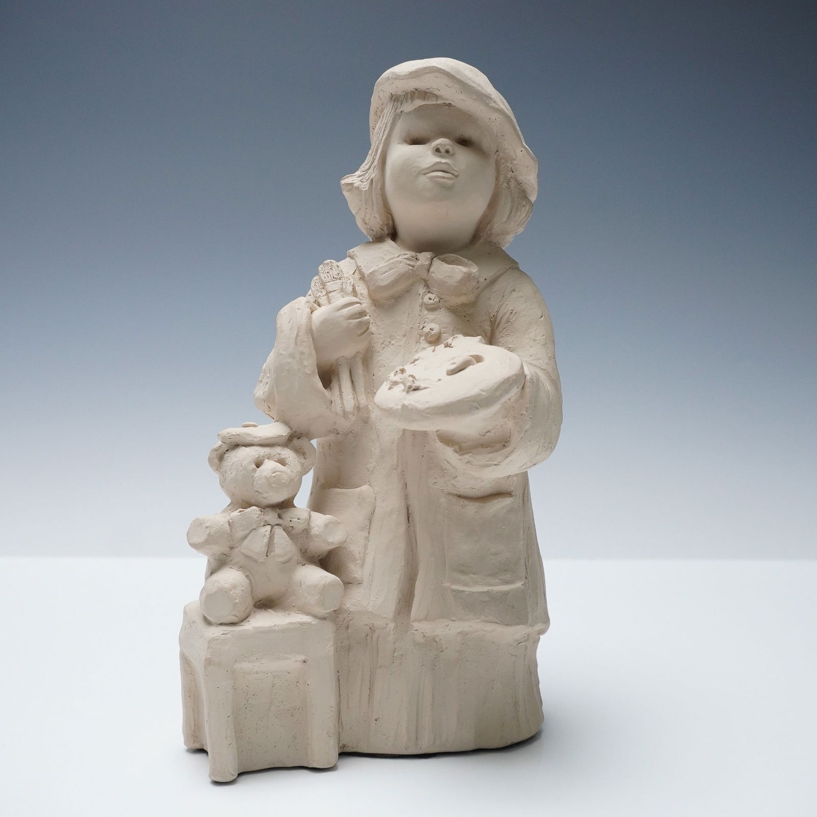 Austin Sculpture Little Artist by Dee Crowley Figurine: A whimsical sculpture by artist Dee Crowley for Austin Sculpture, titled Little Artist (model BE0085). This charming piece features a young child in a painter's smock and beret, holding a palette and