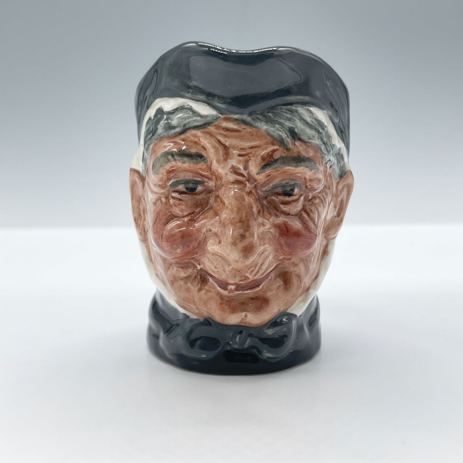 Granny D6520 - Mini - Royal Doulton Character Jug: With tooth. Royal Doulton backstamp. Artist: Max Henk Issued: 1960 - 1983 Dimensions: 2.25"H Country of Origin: England