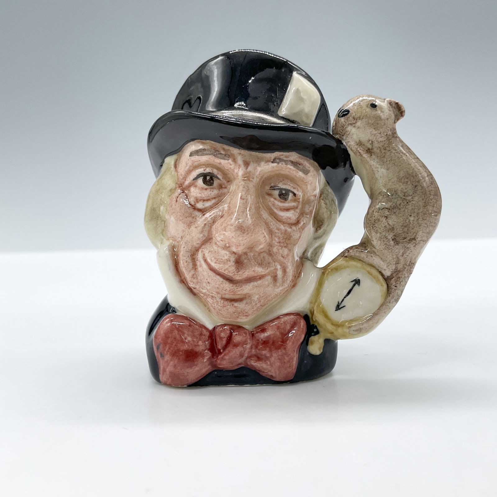 Mad Hatter D6606 - Mini - Royal Doulton Character Jug: Royal Doulton backstamp. Artist: Max Henk Issued: 1965 - 1983 Dimensions: 2.5"H Country of Origin: England