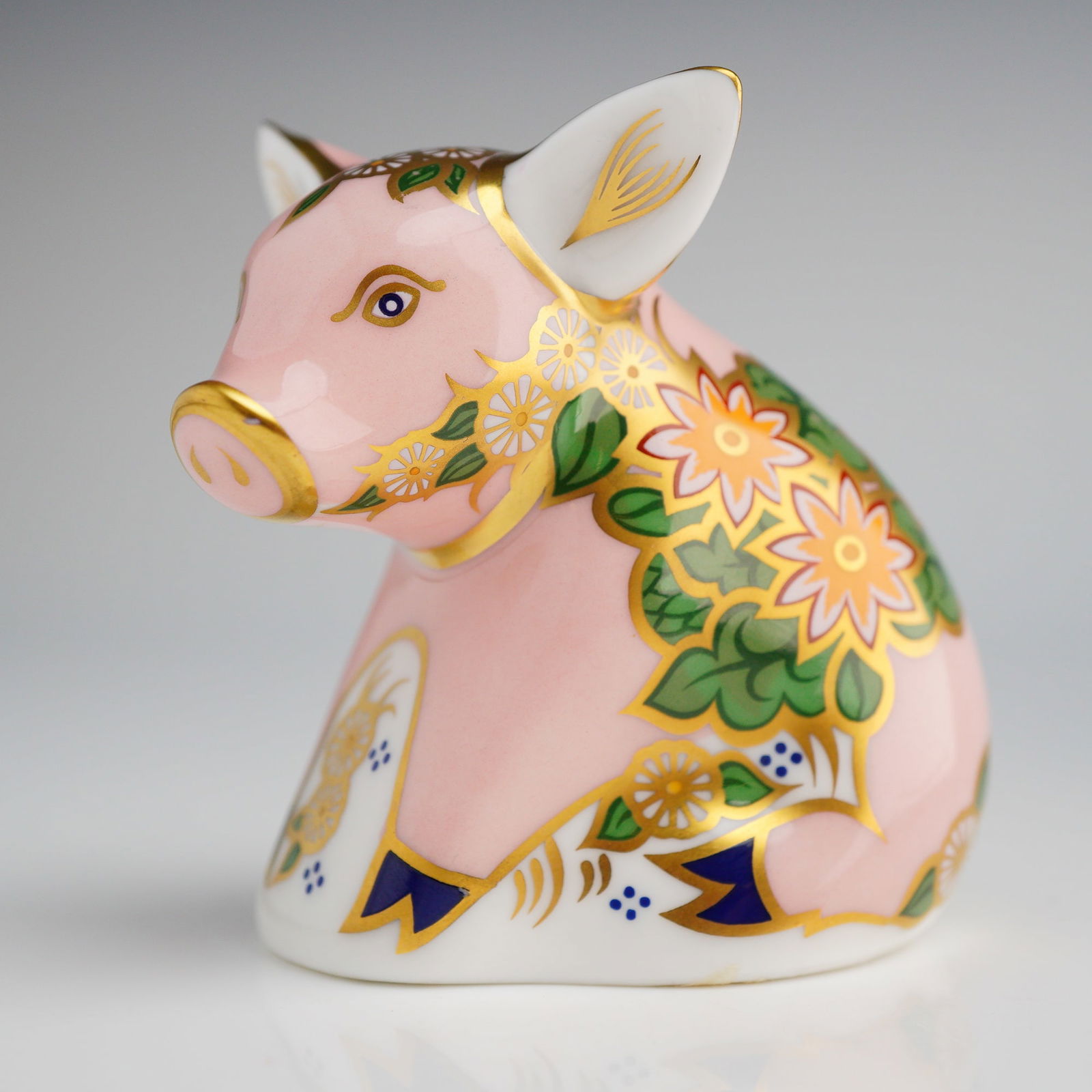 Royal Crown Derby Pickworth Piglet Paperweight: A Royal Crown Derby fine bone china paperweight in the form of a piglet, titled Pickworth Piglet, produced for Sinclairs. The figurine features a pale pink ground decorated with an elaborate floral an