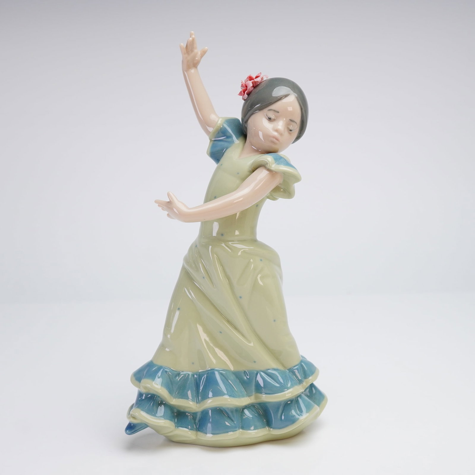 Lladro Flamenco Dancer Porcelain Figurine, Lolita 5192: A Lladro Lolita porcelain figurine depicting a young flamenco dancer in an expressive, dynamic pose. This handcrafted Spanish porcelain figure features a dancer in a pale green gown with tiered blue r