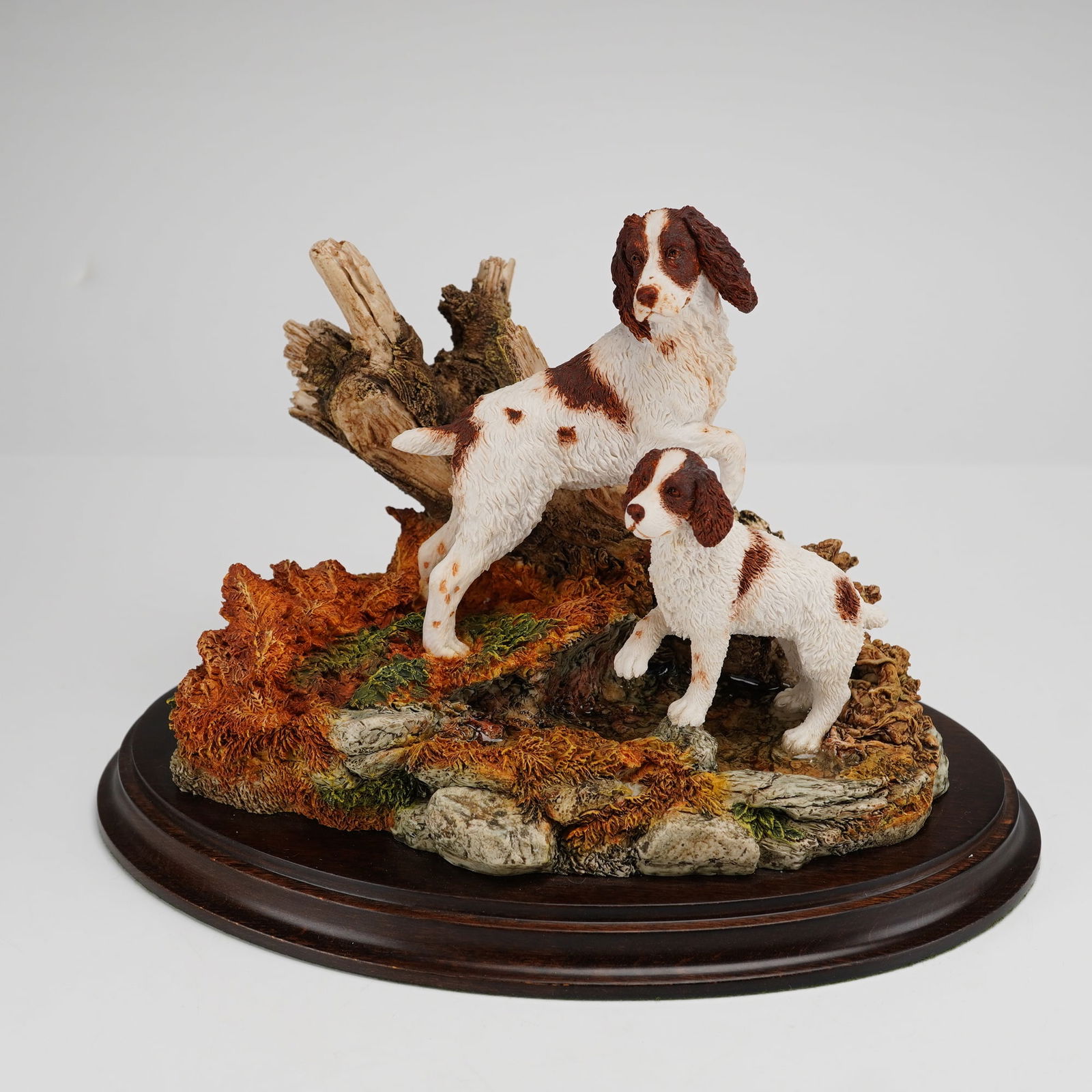 Country Artists Sculpture, New Experience: A Country Artists hand-painted resin tableau titled New Experience, model number 01028. The sculpture depicts an adult Springer Spaniel and a puppy positioned within a naturalistic landscape featuring