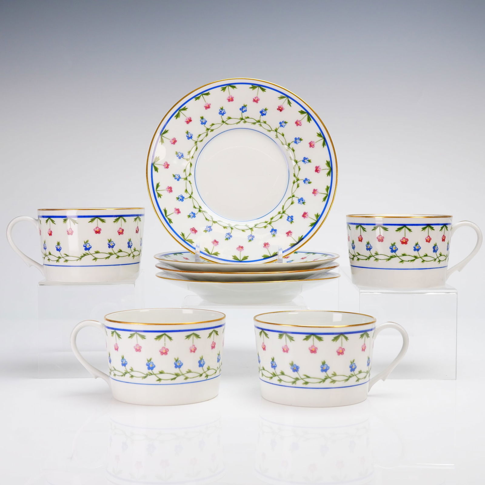4pc Ceralene A. Raynaud Limoges China Cup and Saucer Sets, Lafayette: A collection of four sets, totaling eight pieces, comprising four handled cups and four matching saucers. The decoration features a repeating motif of small stylized pink and blue floral clusters conn