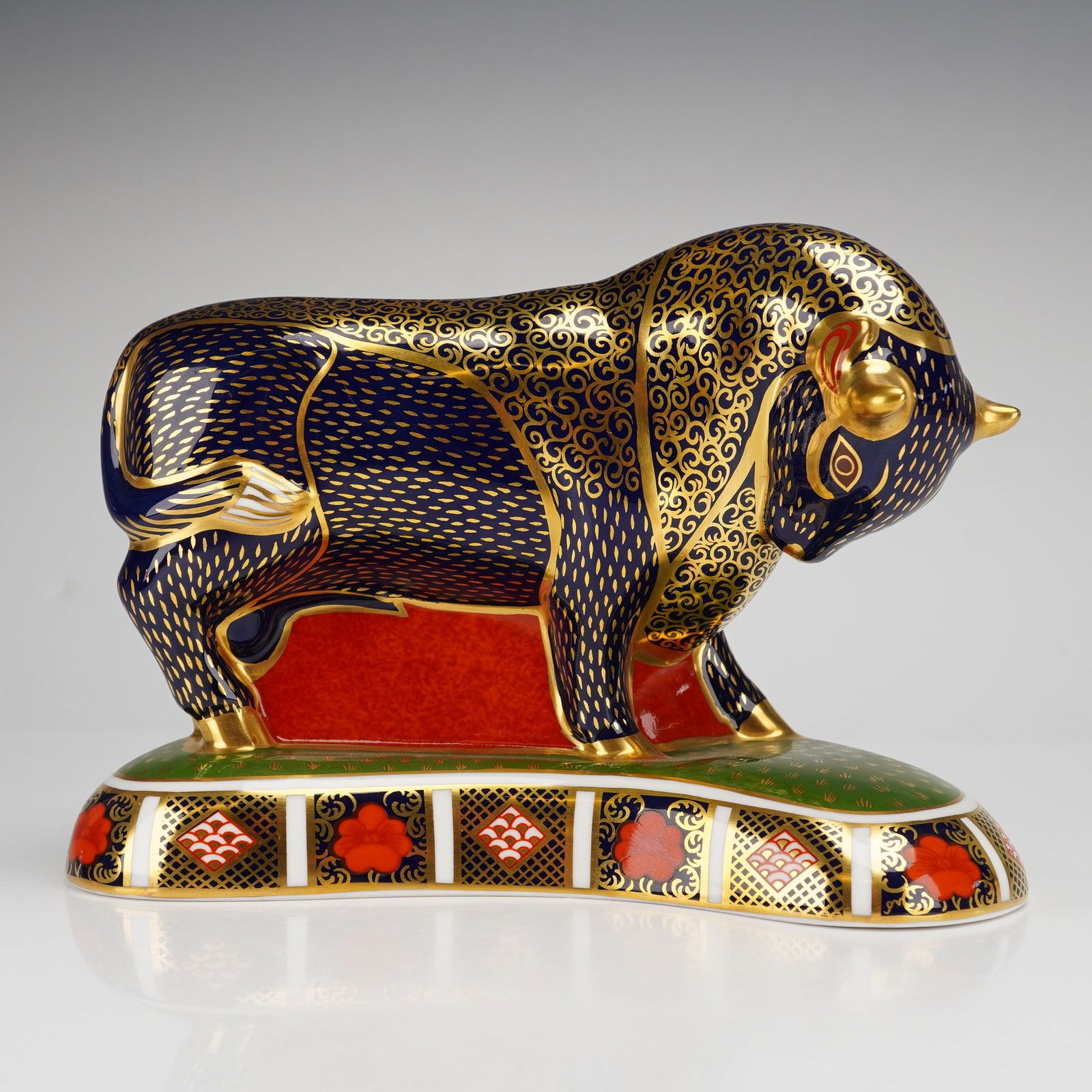 Royal Crown Derby Grecian Bull Paperweight: This Royal Crown Derby paperweight is modeled in a traditional Imari palette. The figure features a cobalt blue ground with iron red accents and 22kt gold gilding. The surface is detailed with gold sc