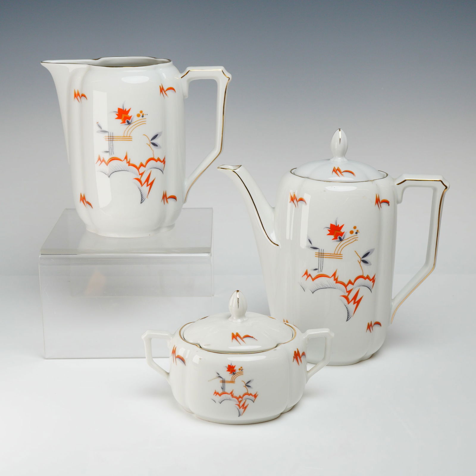 3pc Johann Seltmann Bavaria Art Deco Covered Coffee Service: The service comprises a Covered Coffee Pot, a tall Creamer, and a Lidded Sugar Bowl. The set is executed in white porcelain featuring a streamlined Art Deco style with fluted, paneled bodies and angul